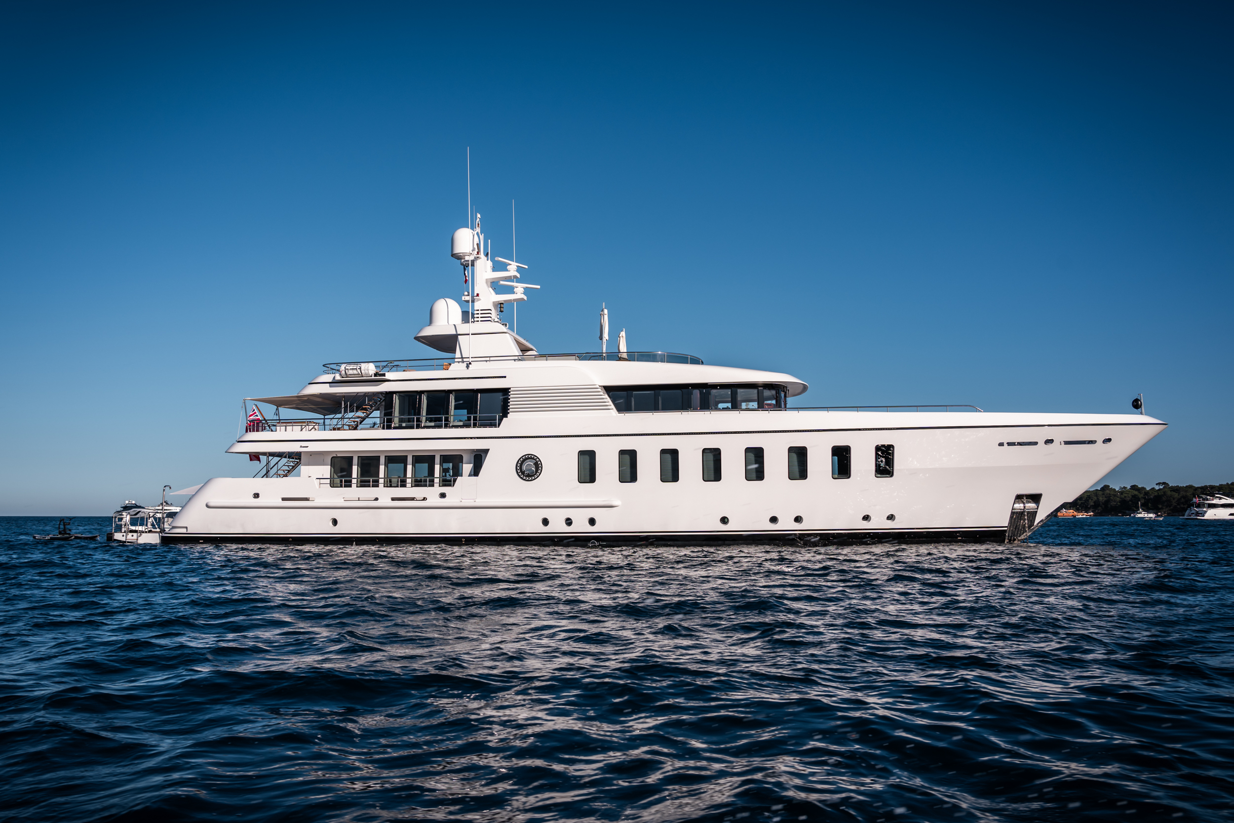 Motor yacht Gladiator facing right in the blue ocean with blue sky