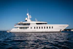 Motor yacht Gladiator facing right in the blue ocean with blue sky