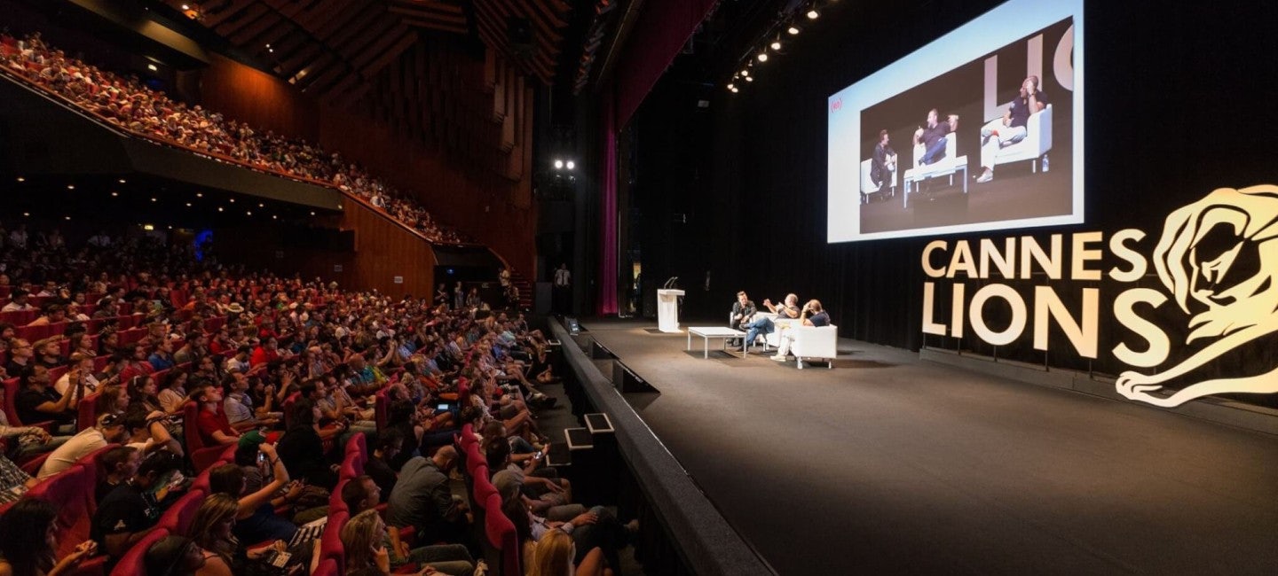 A captivated audience in a theater, listening attentively to a conference during the Cannes Lions International Festival