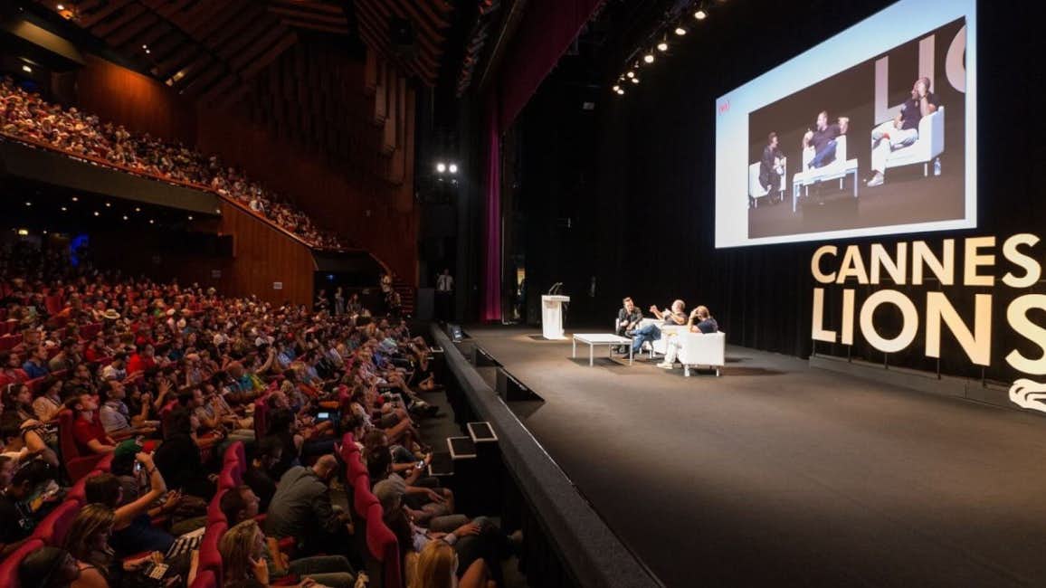 A captivated audience in a theater, listening attentively to a conference during the Cannes Lions International Festival