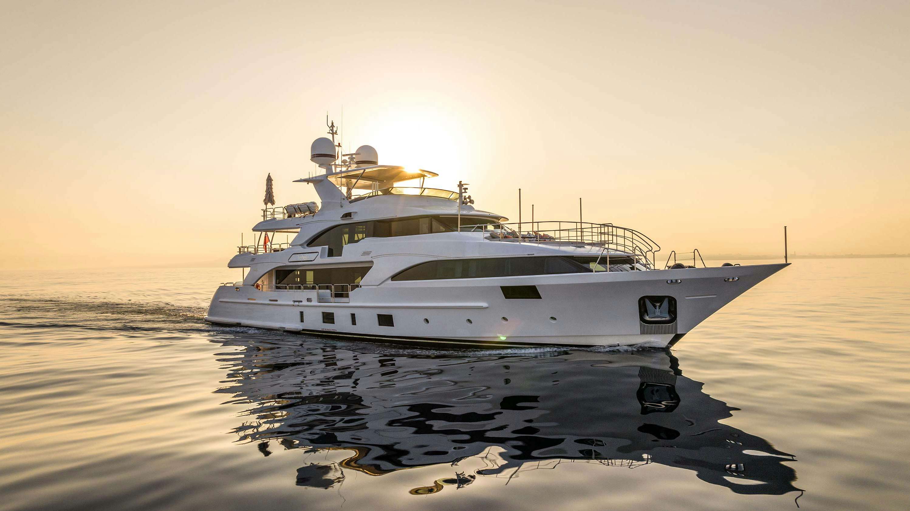right facing profile of SAFAD, benetti 121, superyacht, white superyacht in the water at sunset