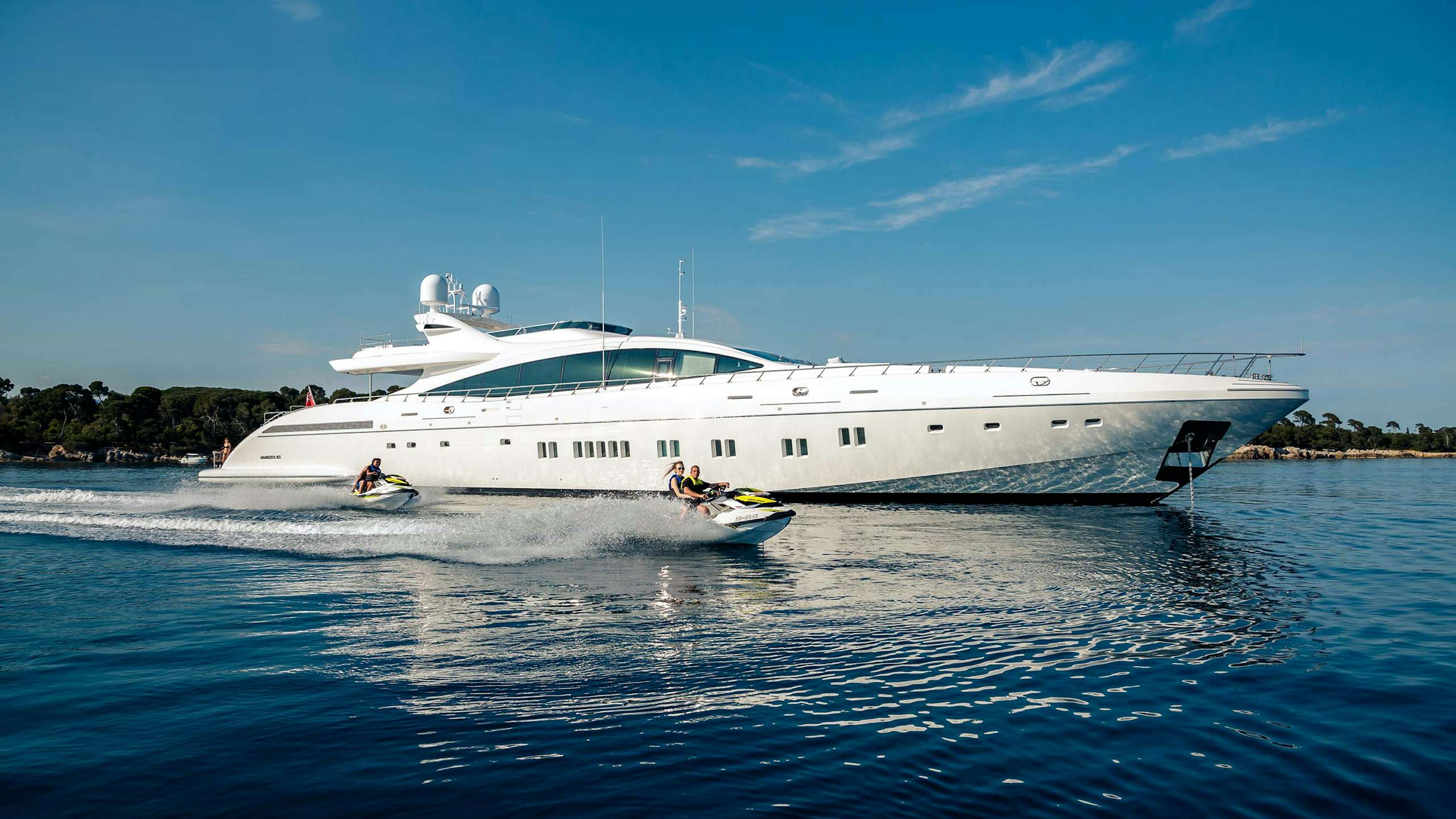 100 feet yacht for charter cruising the mediterranean alongside jet skis