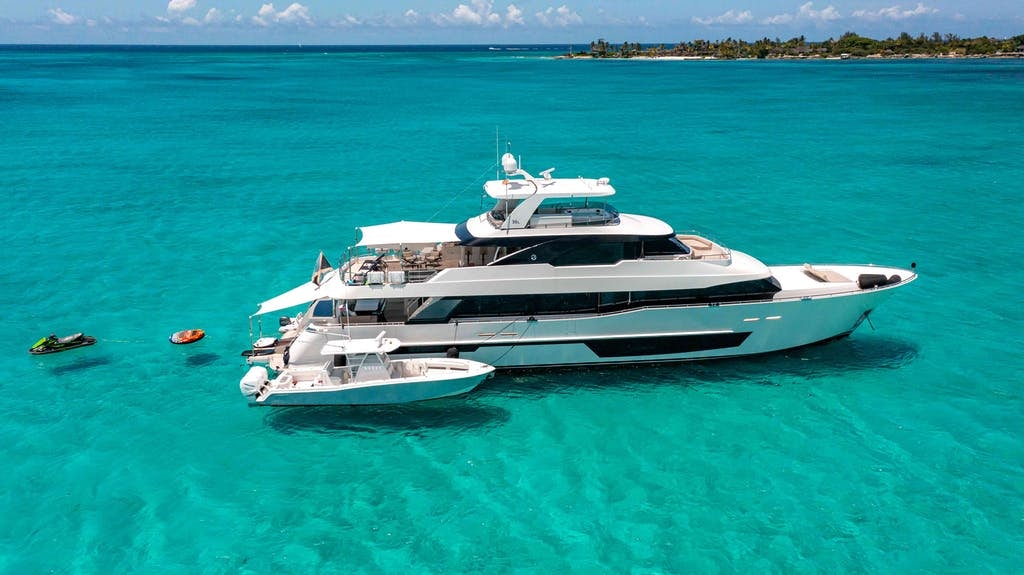 118' (35.97m) Ocean Alexander Yacht for Charter I C anchored in the Bahamas with her tenders and toys