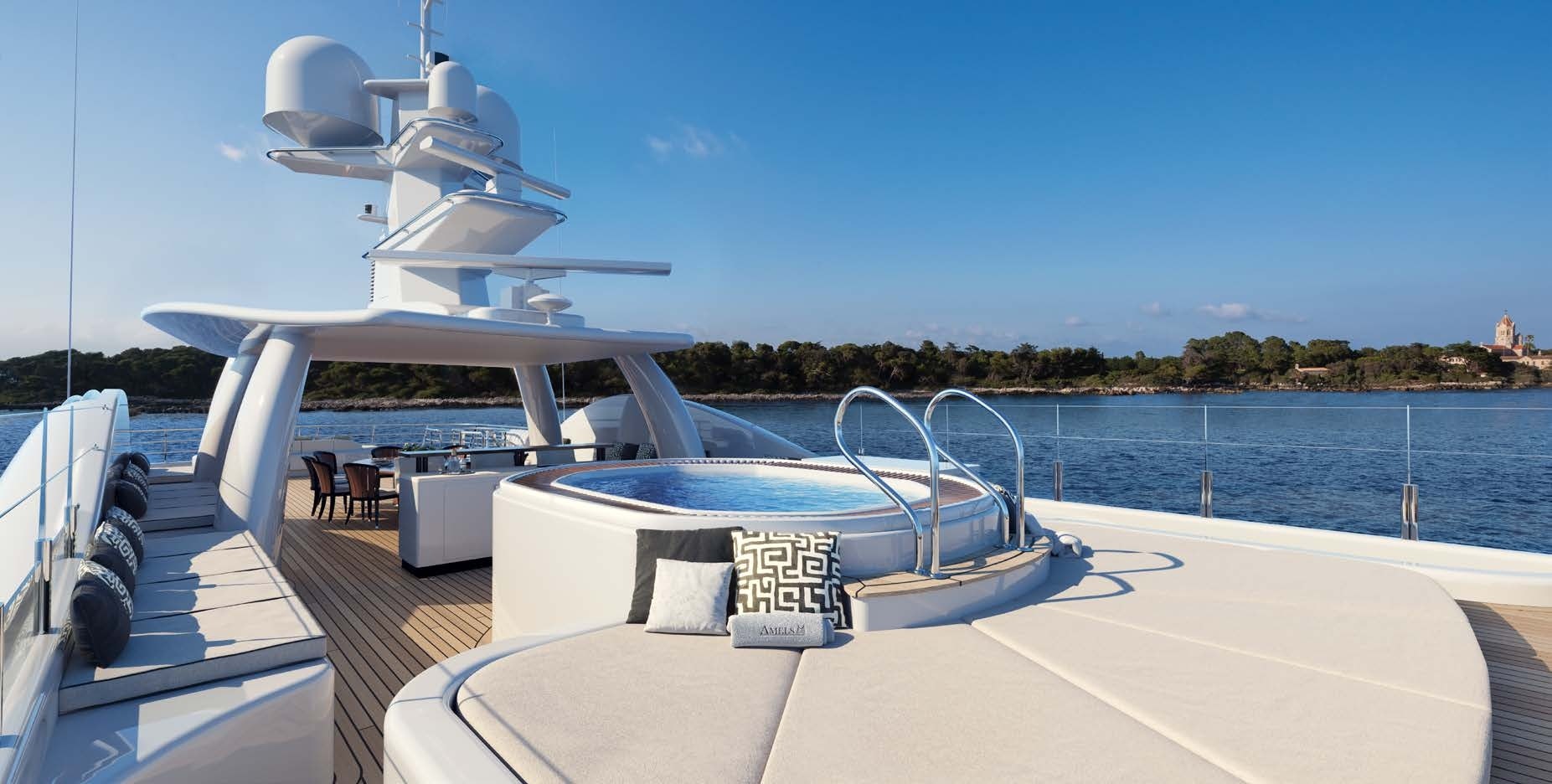 The sun deck of the Amels 180 Superyacht featuring a jacuzzi and dining area, offered by Northrop & Johnson.