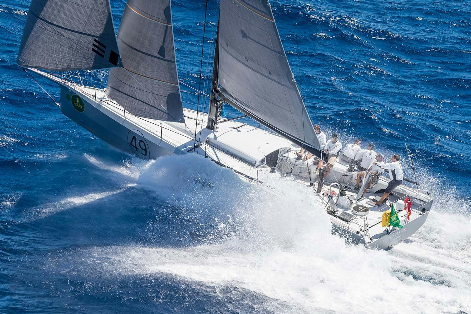 action shot of an infiniti sailing yacht making its way over the waves