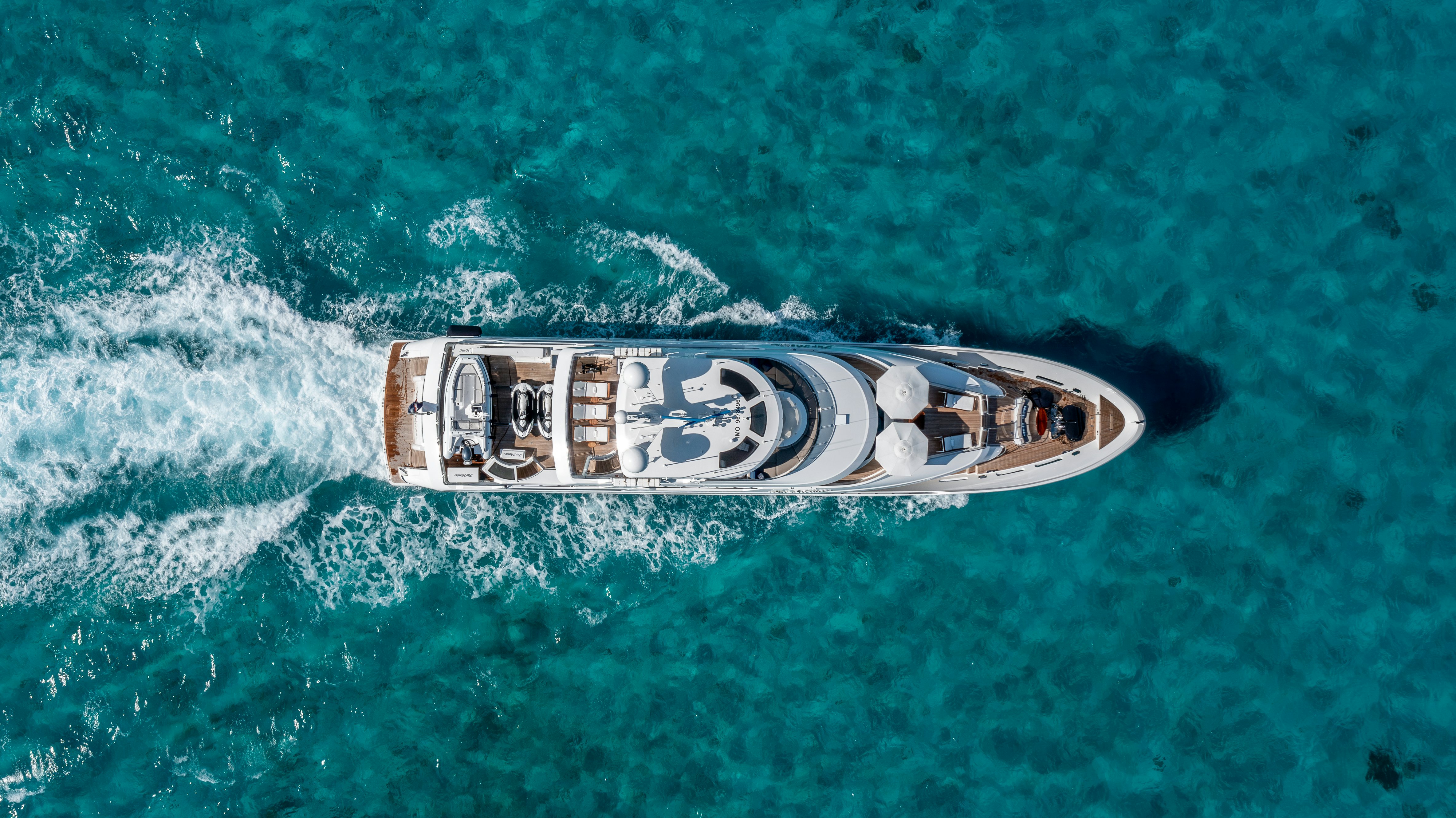 Far niente yacht cruising in blue water view from above