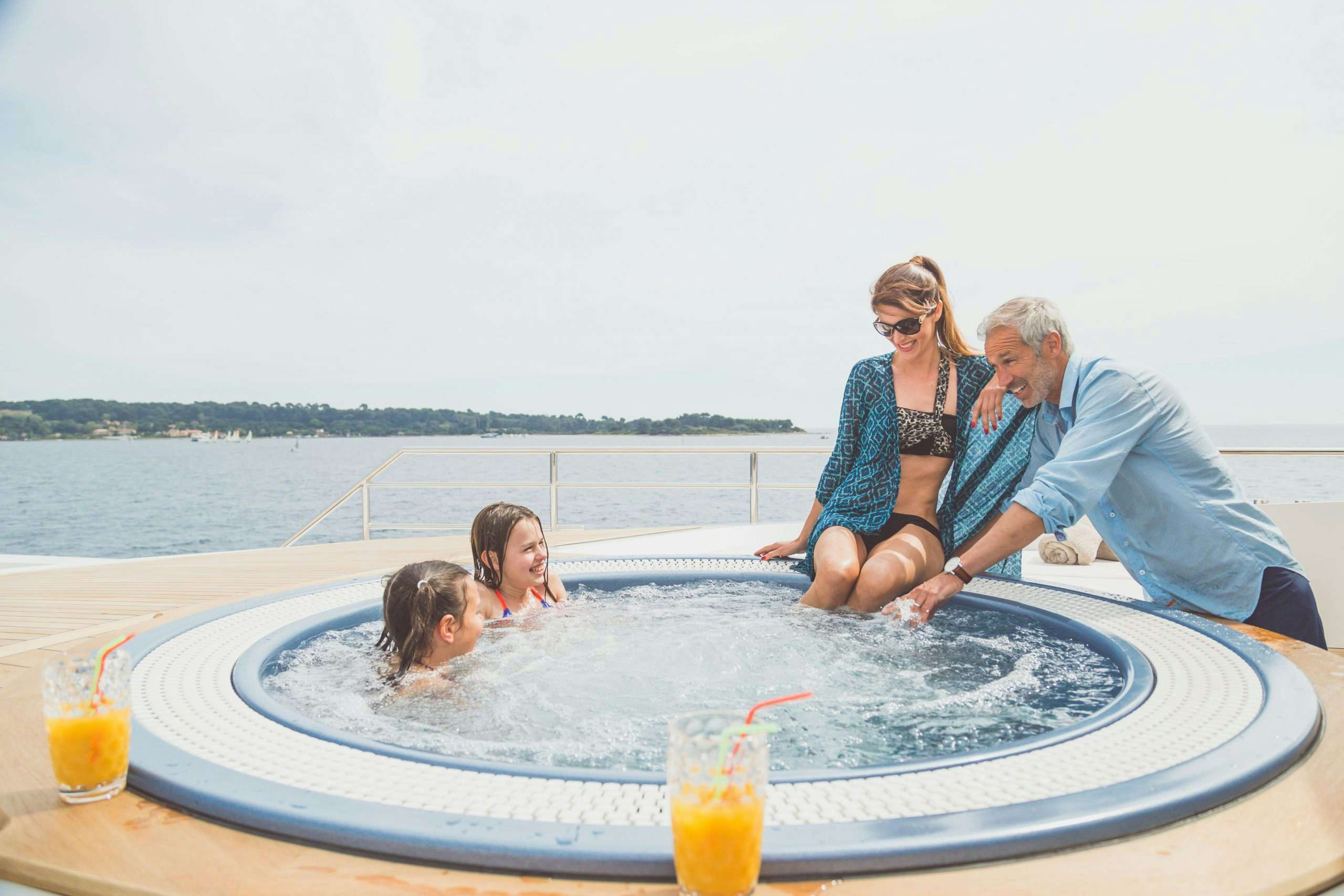 Family playing in the Jacuzzi aboard Tankoa superyacht Surete