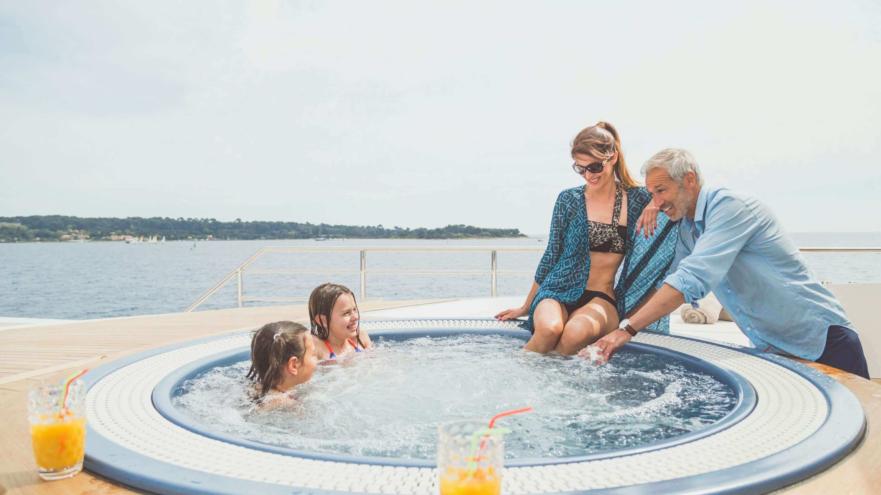 Family playing in the Jacuzzi aboard Tankoa superyacht Surete