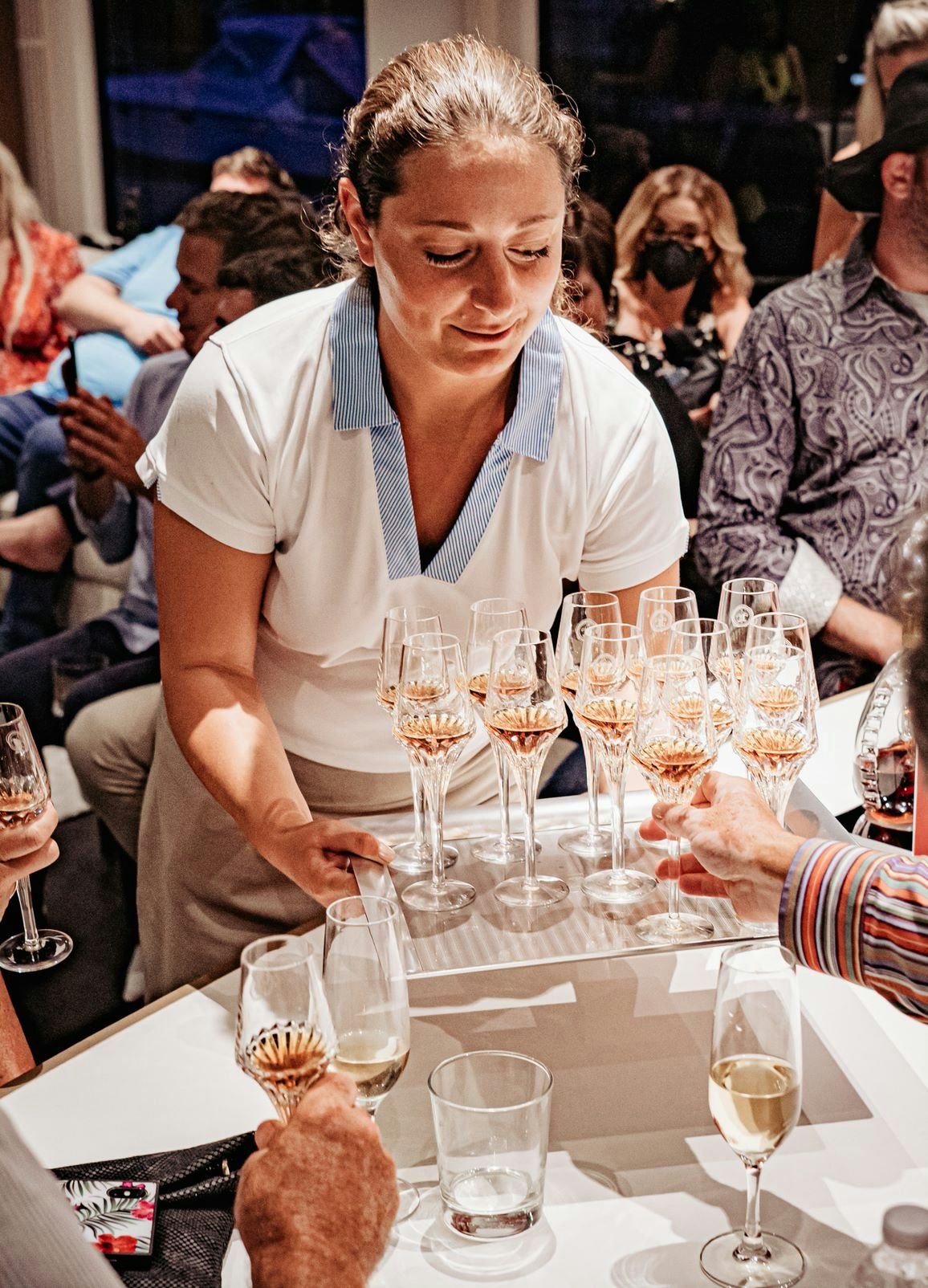 woman serving Louis XIII aboard a yacht