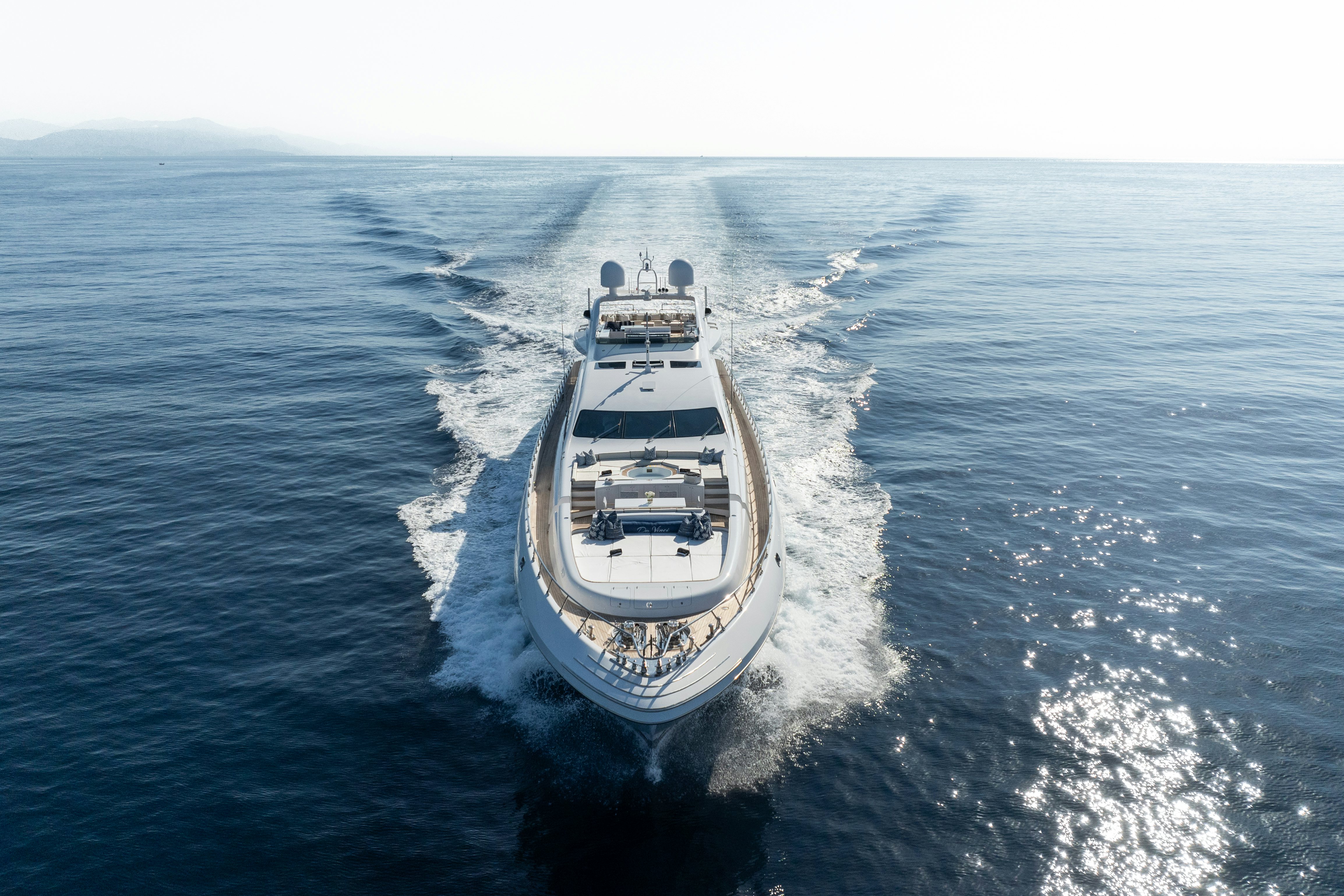 DA VINCI white yacht cruising head on in the blue ocean