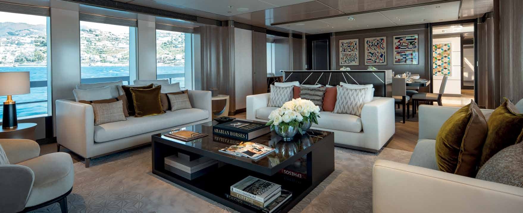 Elegant interior living space of a Heesen 55 Steel yacht, with a sea view, available through Northrop & Johnson.