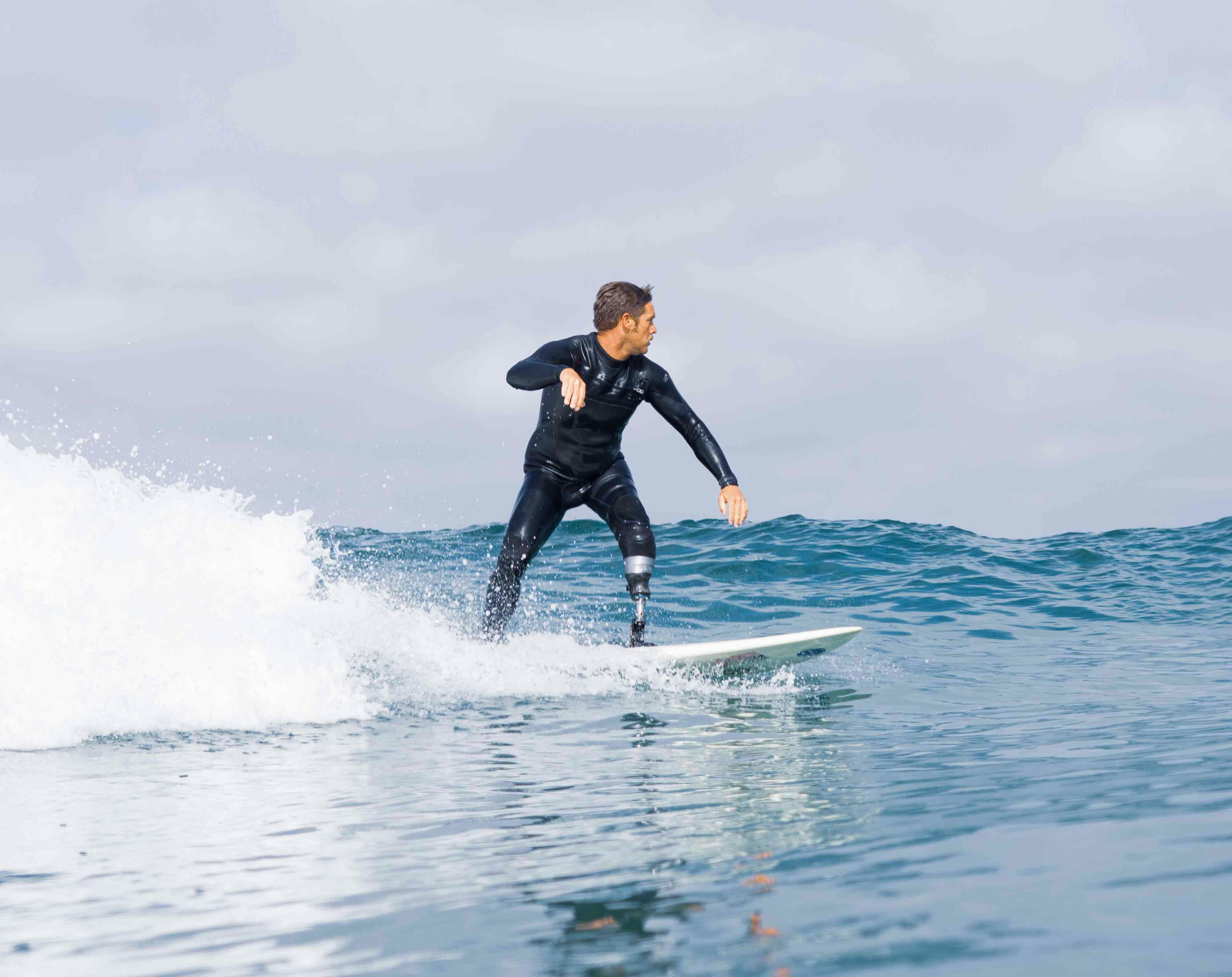 Veteran surfing with custom leg equipment