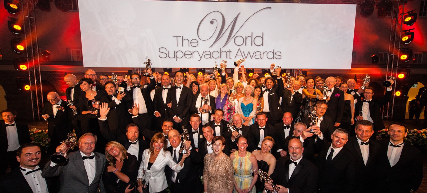 A jubilant gathering of people celebrating after the winners were revealed at The World Superyacht Awards.