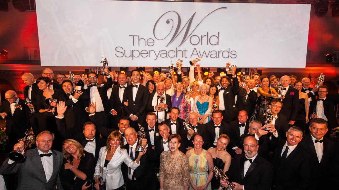 A jubilant gathering of people celebrating after the winners were revealed at The World Superyacht Awards.