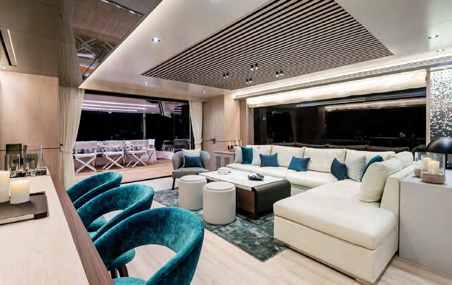 Inside the Horizon FD 80 yacht's salon, blending plush seating and elegant design with open terrace views.