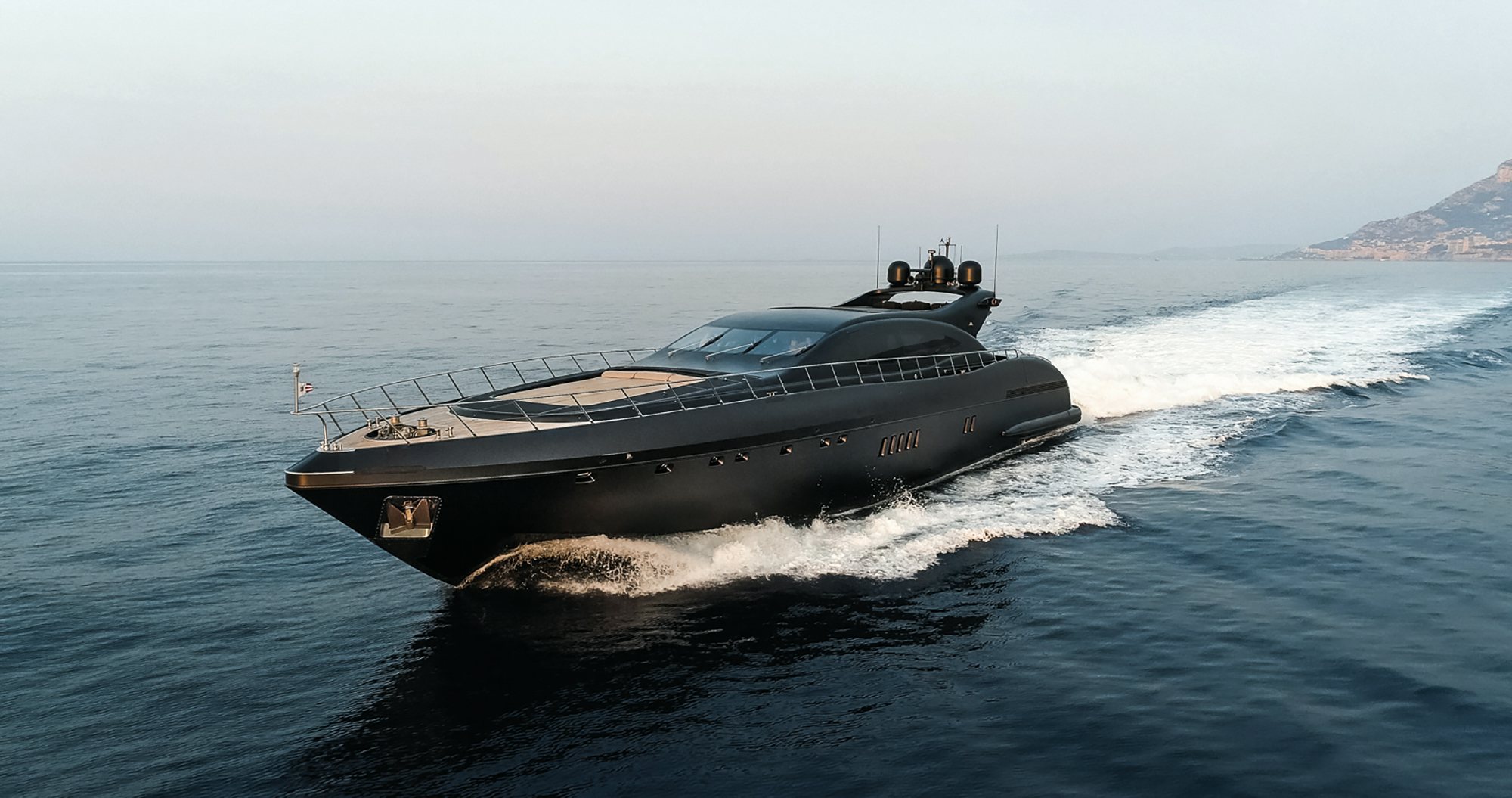The Mangusta 108 yacht showcases its sleek design as it cruises through the water.