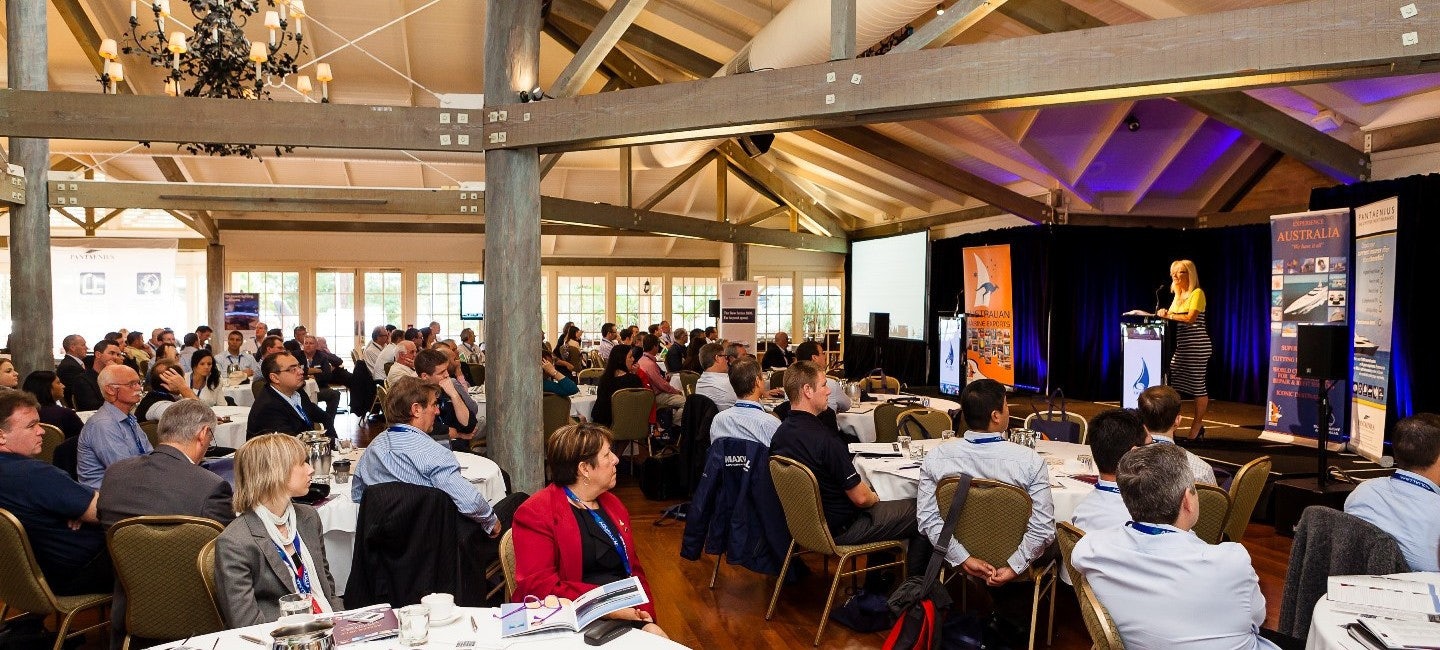 A group of attendees immersed in thought and discussion during the ASMEX event conference.