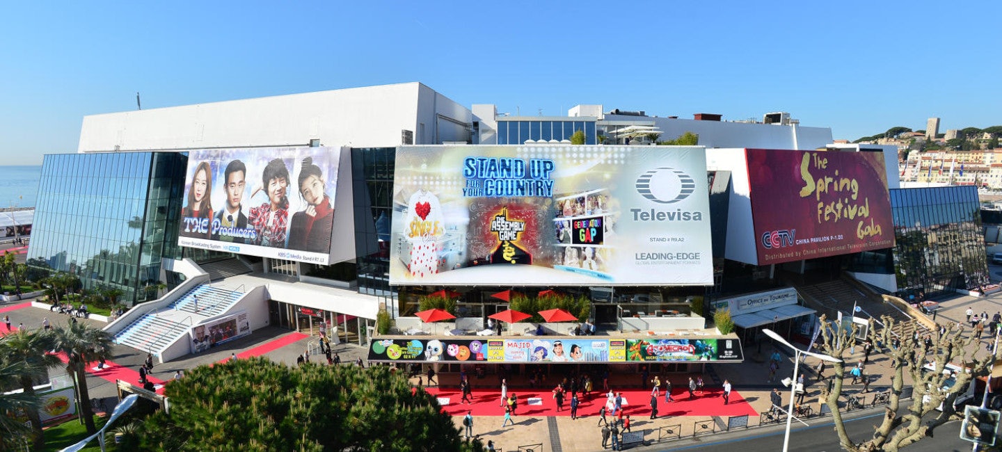 A picturesque view of the Cannes Palais du Festival bathed in sunlight during a sunny day, providing a stunning backdrop for the MIDEM event.