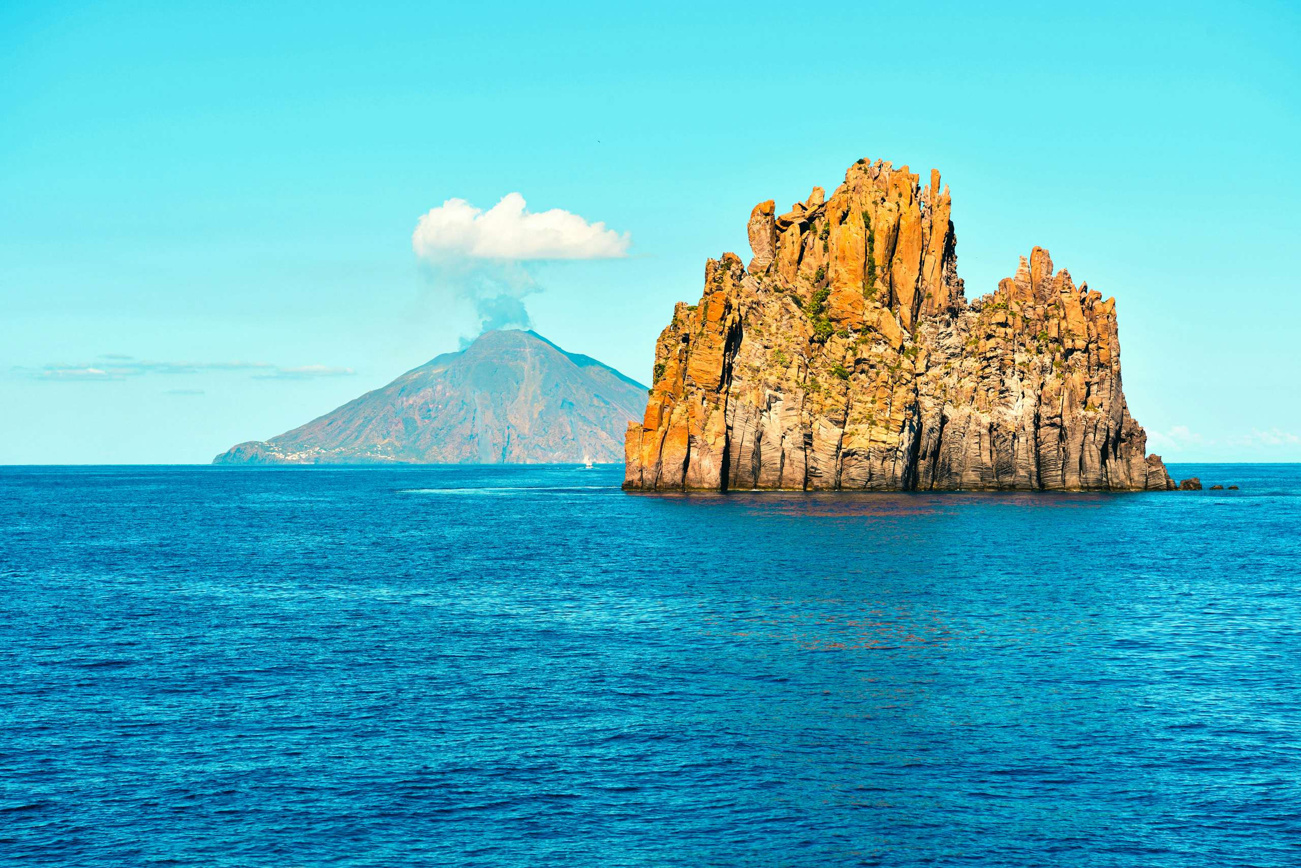 A unique rocky islet off the coast of Sicily, viewed from a yacht chartered with N&J, showcasing potential exploration sites.