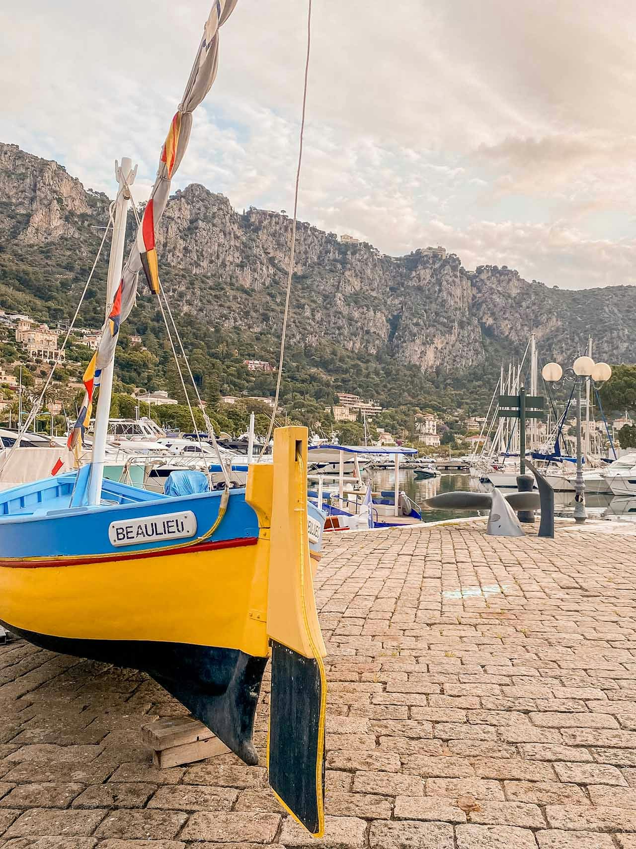 An old wooden fishing boat called Beaulieu resting on the tender dock at the port of Beaulieu-sur-Mer