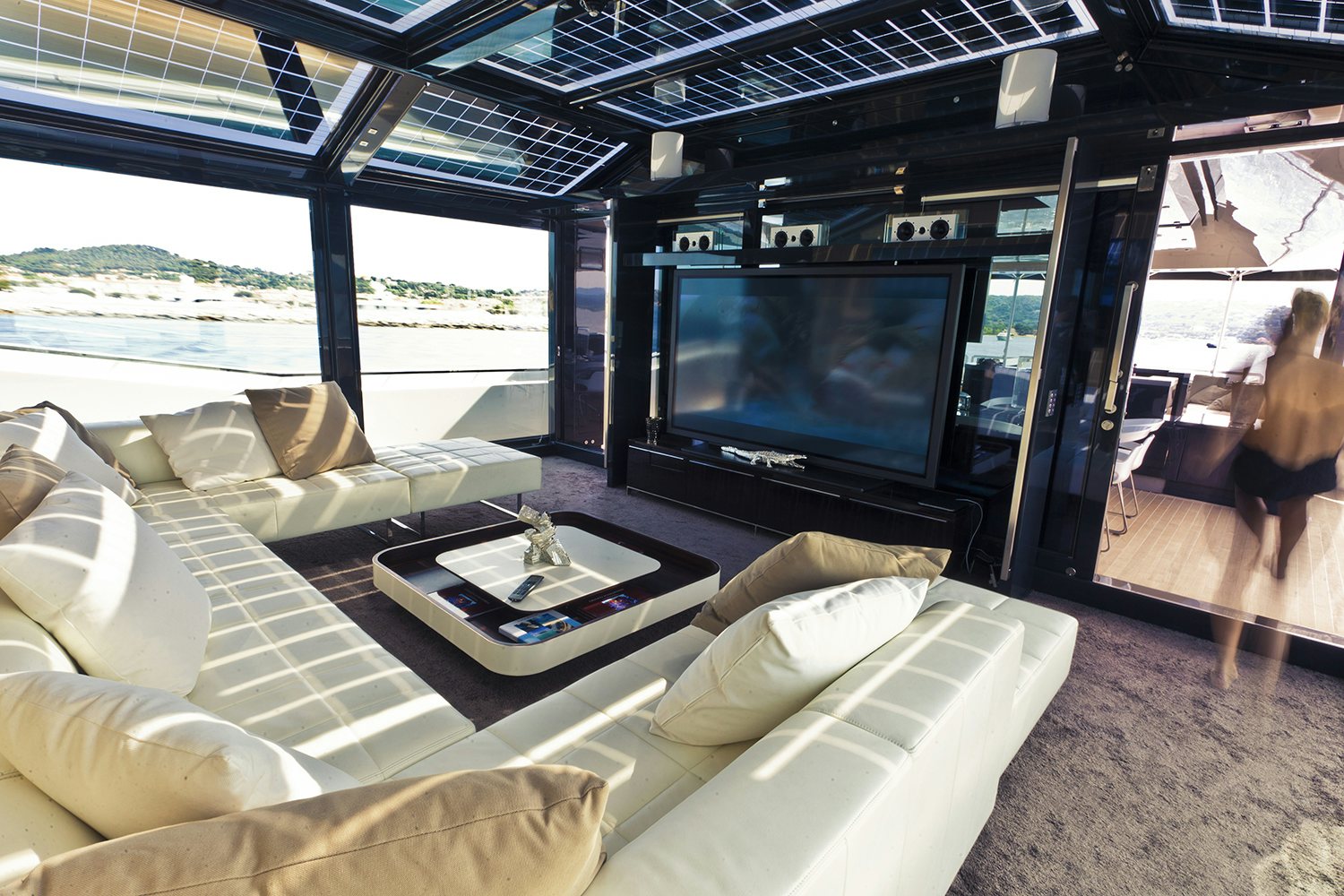 Arcadia 115 yacht indoor lounge space with opening windows and a sofa Arcadia 115 yacht indoor lounge space with opening windows and a sofa