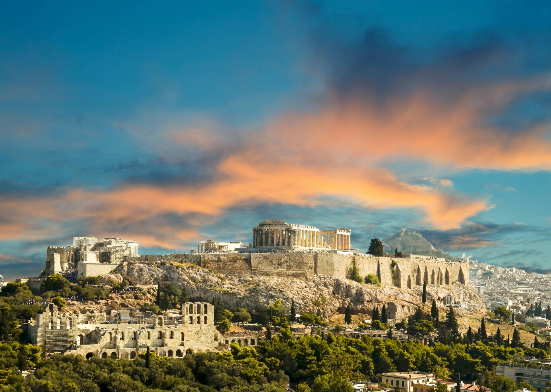 The historic skyline of Athens, viewed at sunset, featuring the Acropolis, a highlight of any Greek yacht charter.