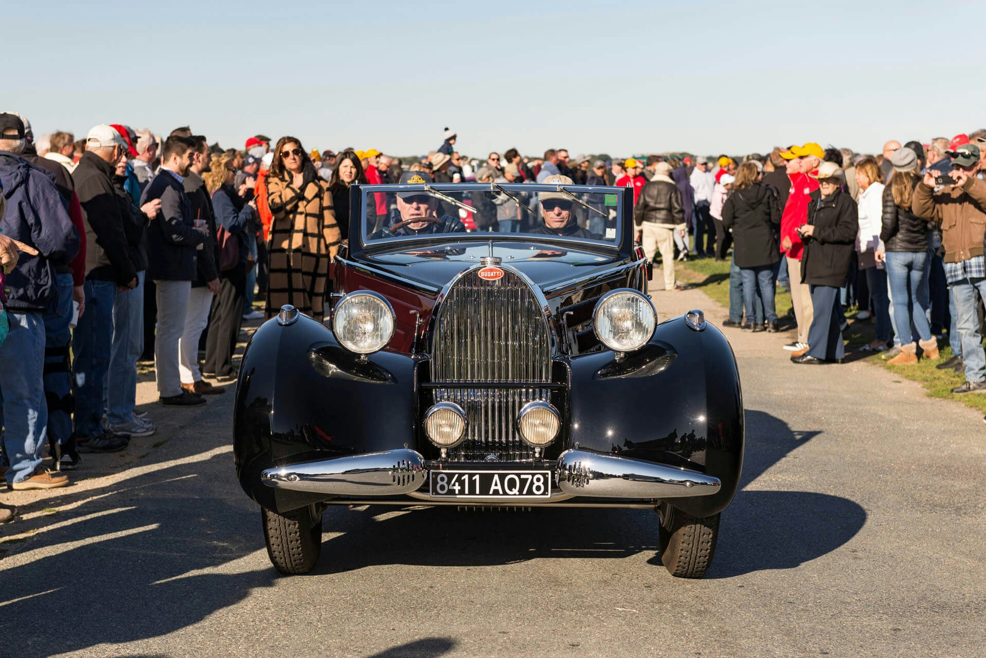 People surrounding a classic Bugati at Audrain&#039;s Newport Concours Motor Week