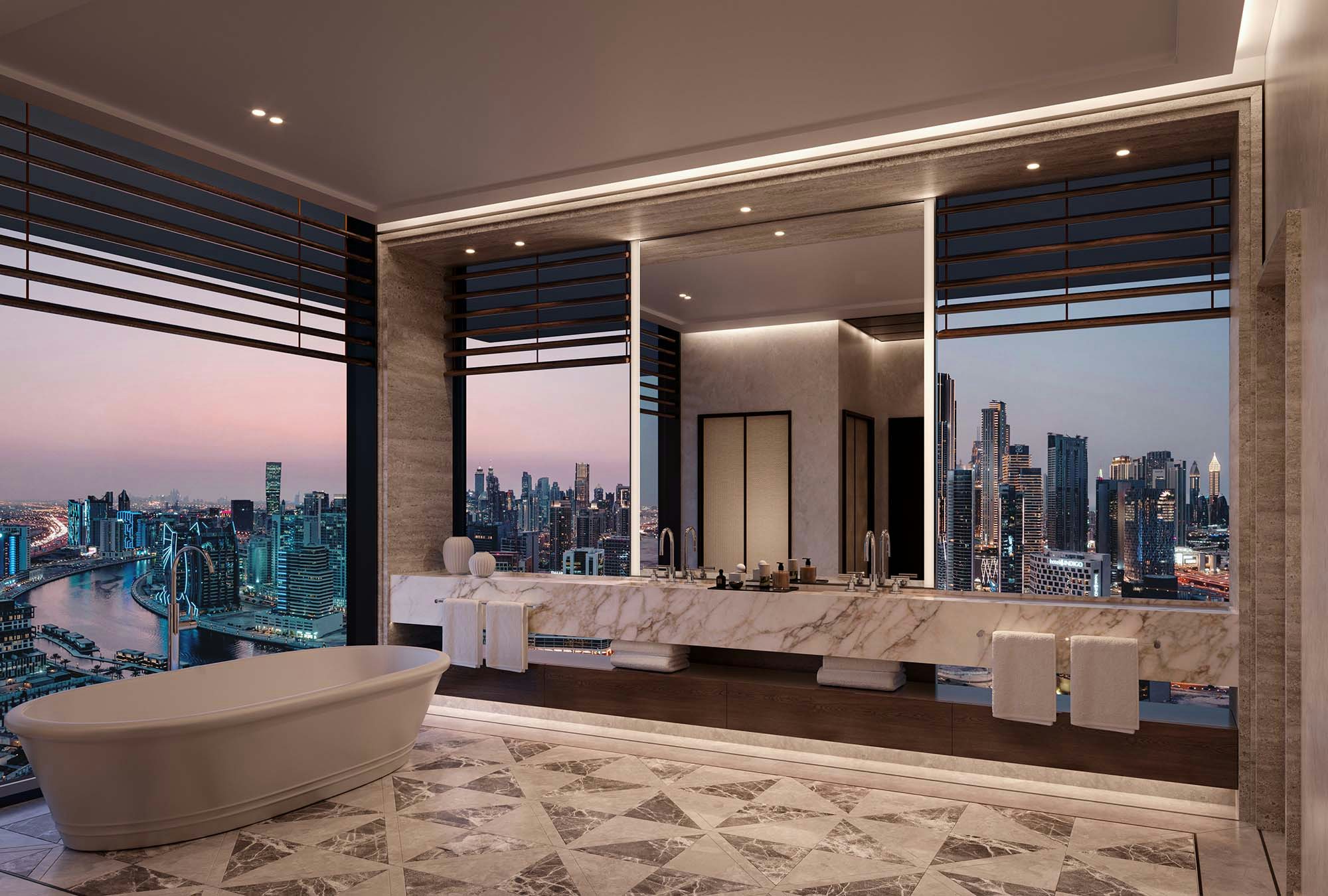 Vela by Omniyat luxury property in Dubai cityscape of a big city at nighttime interior marble bathroom with floor to ceiling windows