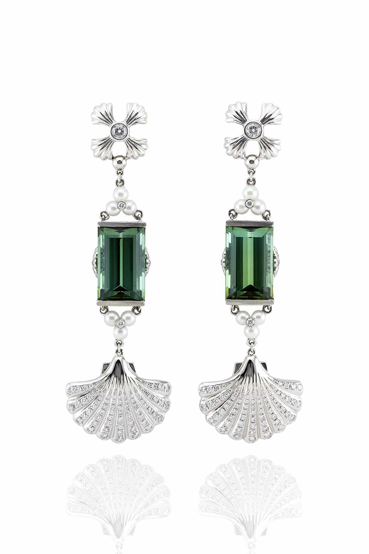 Precious green pendant earrings with diamond studs and diamond-encrusted seashells on a white background