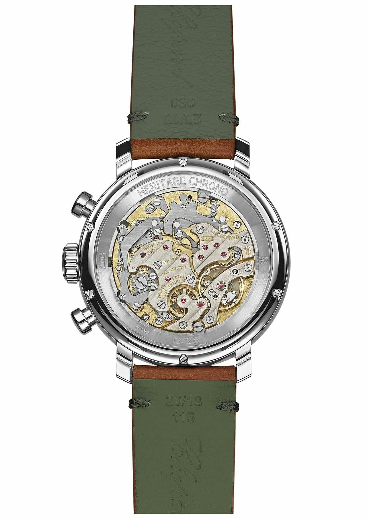 The back of a silver watch with green straps on a white background