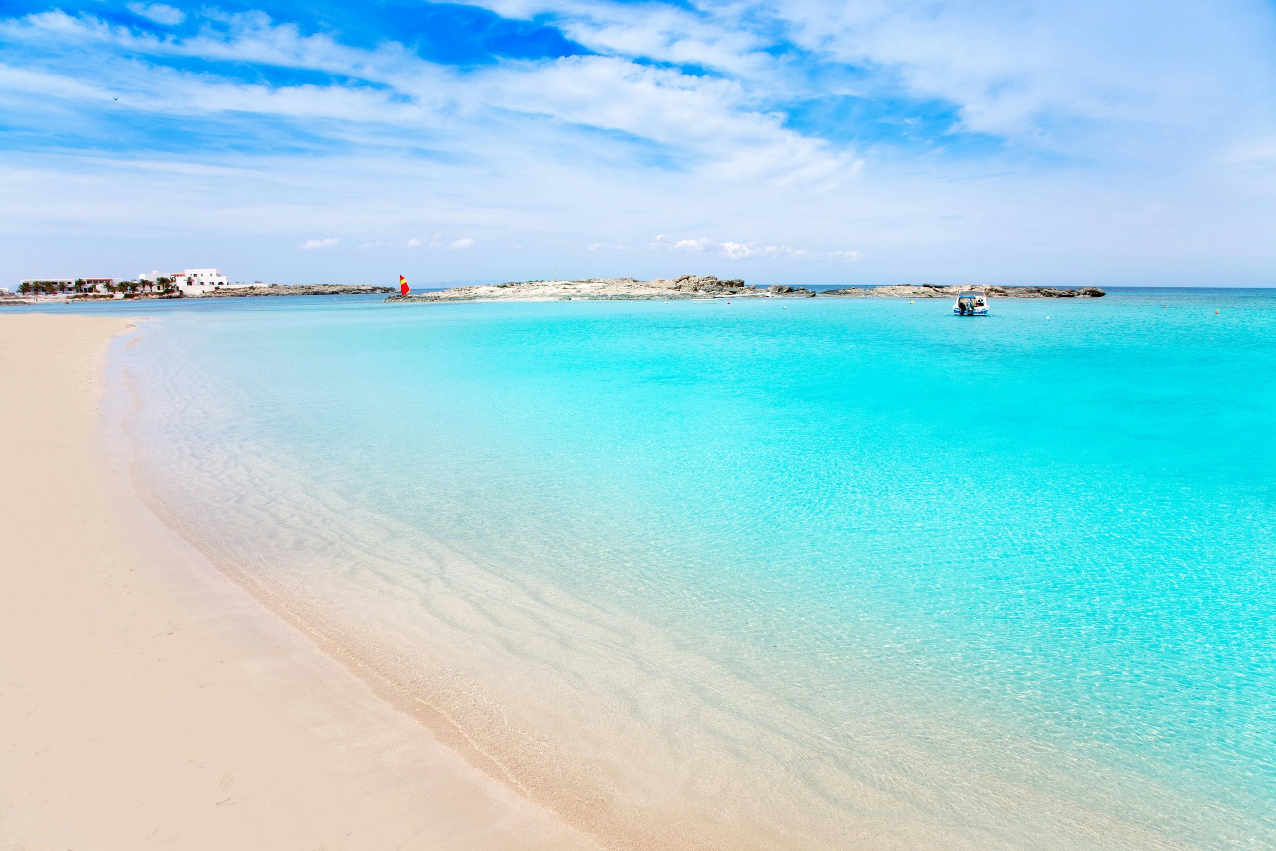 Pristine white sands of Formentera's coastline meet the turquoise sea, inviting peaceful yacht mooring.