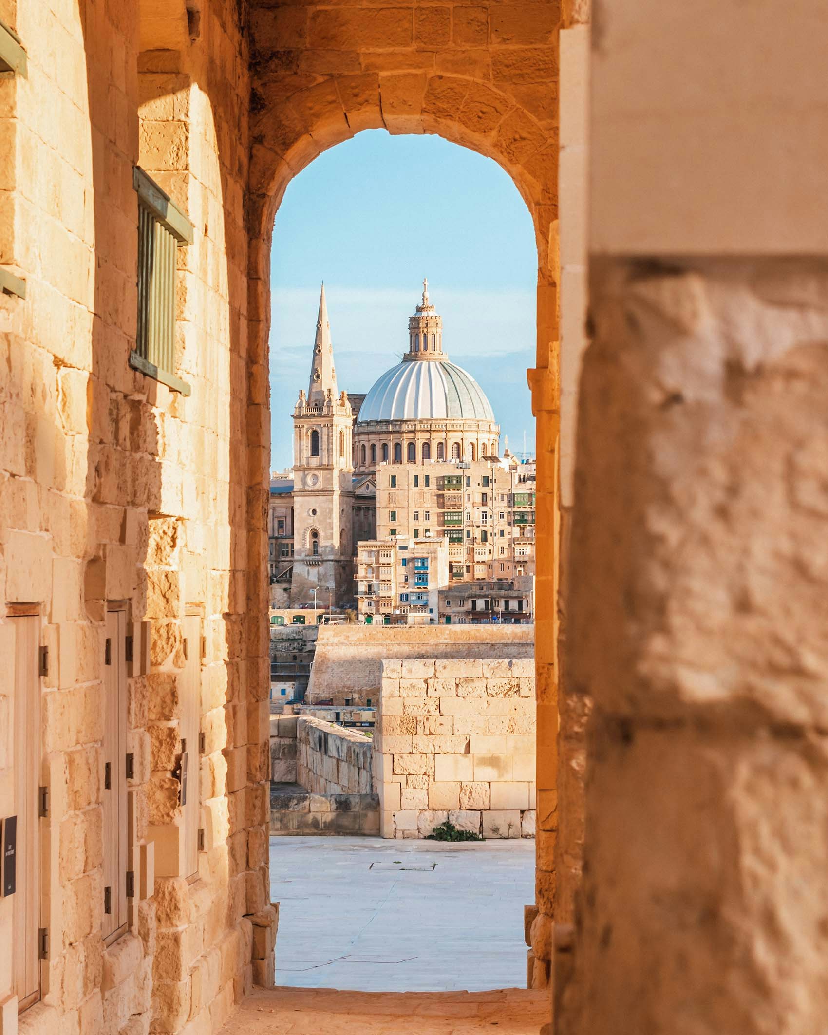 Basilica of Our Lady of Mount Carmel, Valletta, Malta portrait of old, ornate buildings through archways