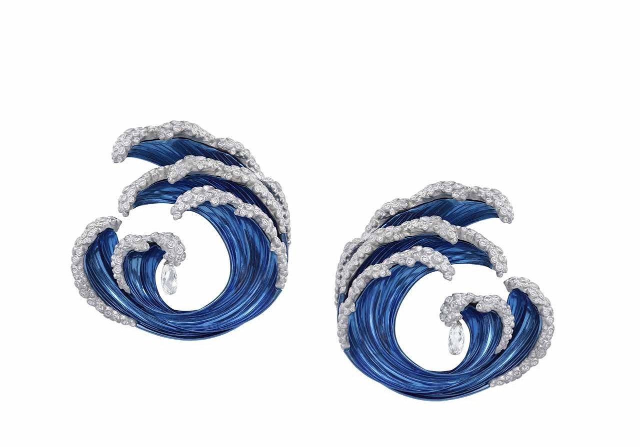Blue Chopard earrings in the shape of waves with diamonds on a white background