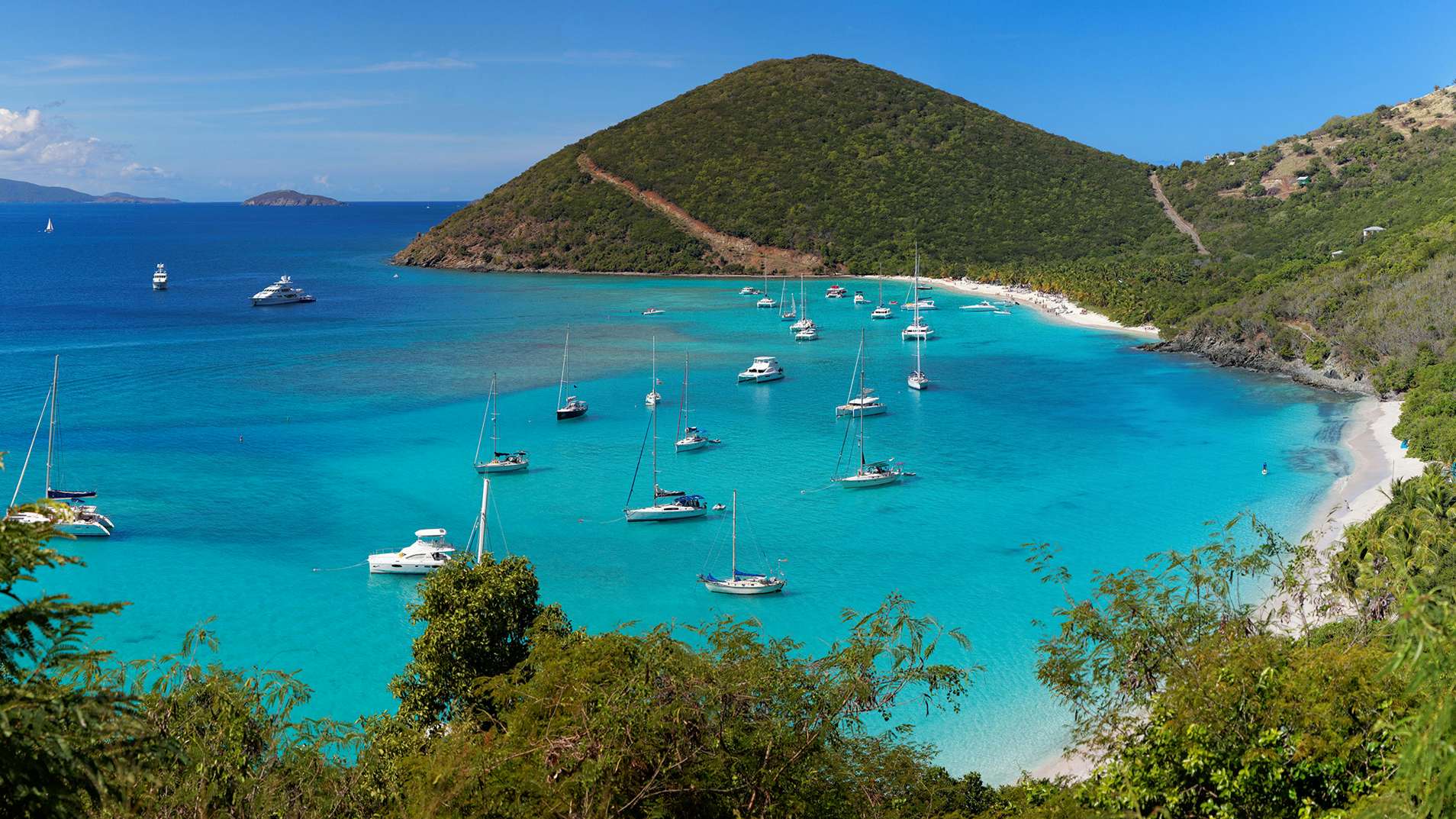 BVI Yacht for Charter - Panoramic view of tropical shoreline in British Virgin Island (BVI), Caribbean with yachts anchored