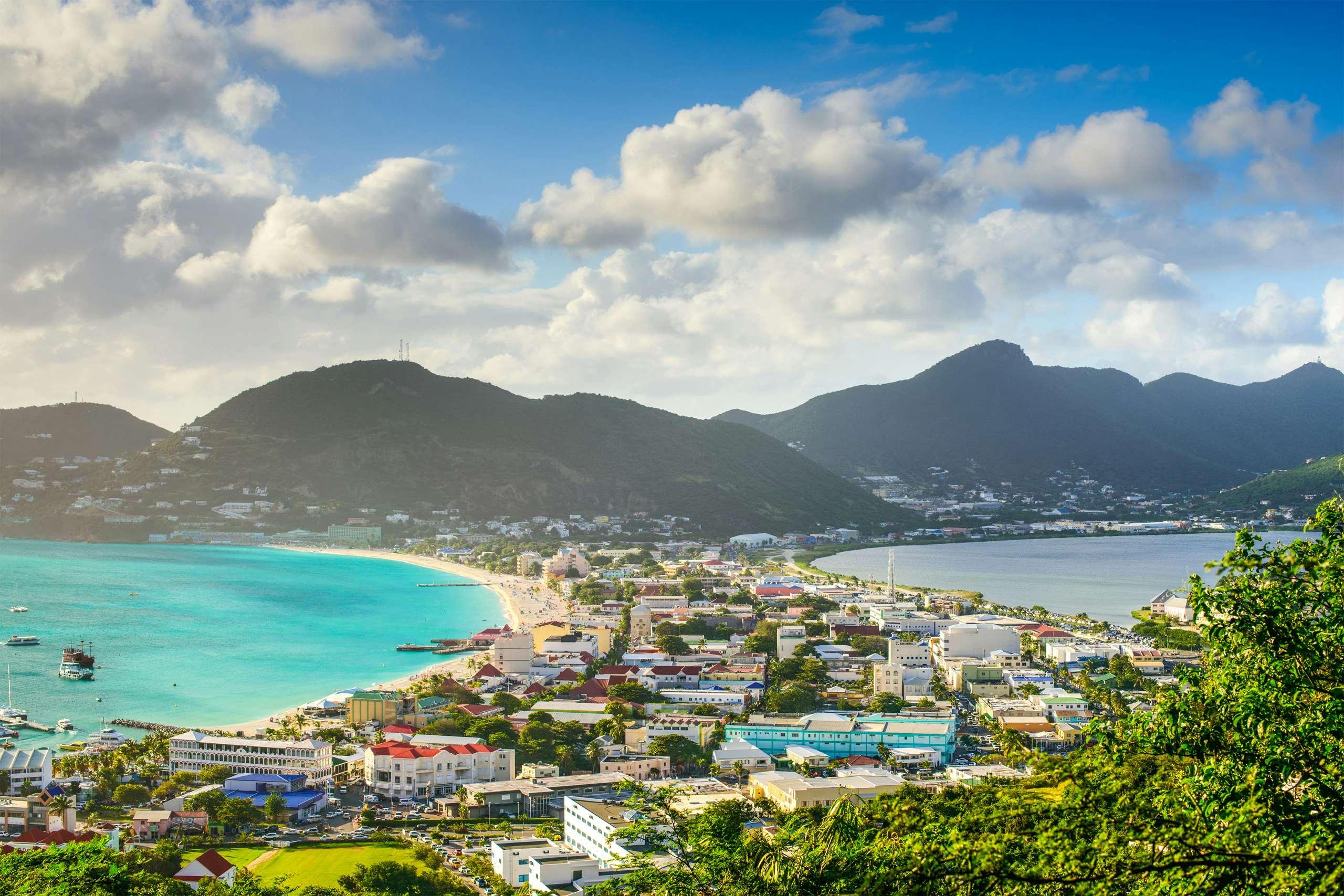 Experience the epitome of luxury with a St. Maarten Crewed Yacht Charter, showcasing an enchanting aerial view of St. Martin's coastline, where blue waters meet sandy shores in Caribbean splendor.