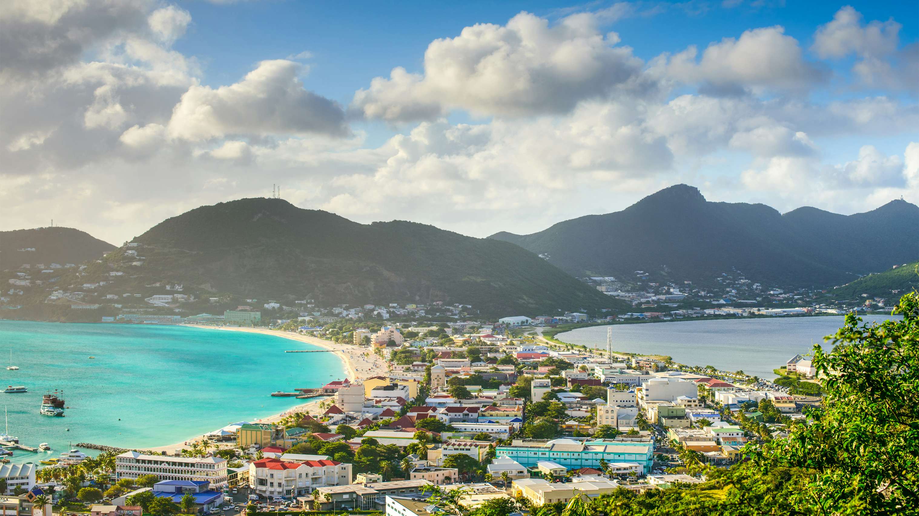 Experience the epitome of luxury with a St. Maarten Crewed Yacht Charter, showcasing an enchanting aerial view of St. Martin's coastline, where blue waters meet sandy shores in Caribbean splendor.