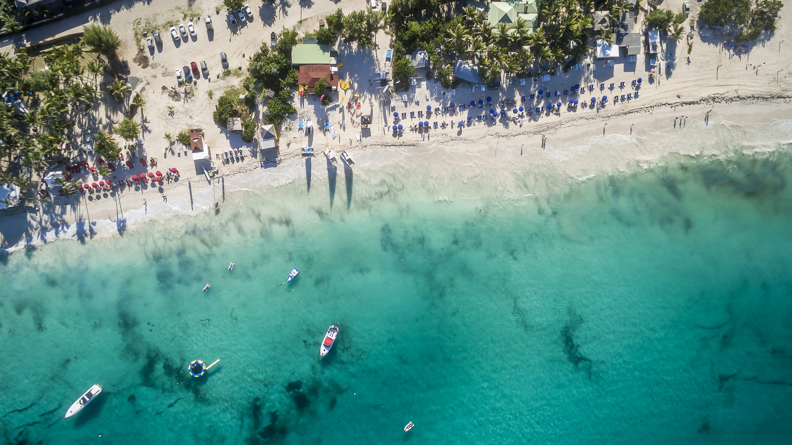 St. Maarten Charter Yacht Delight: Aerial View of Orient in St. Martin Experience the allure of St. Maarten Charter Yacht as you soar over Orient in St. Martin, revealing pristine waters, sandy shores, and the charm of the Caribbean from above.