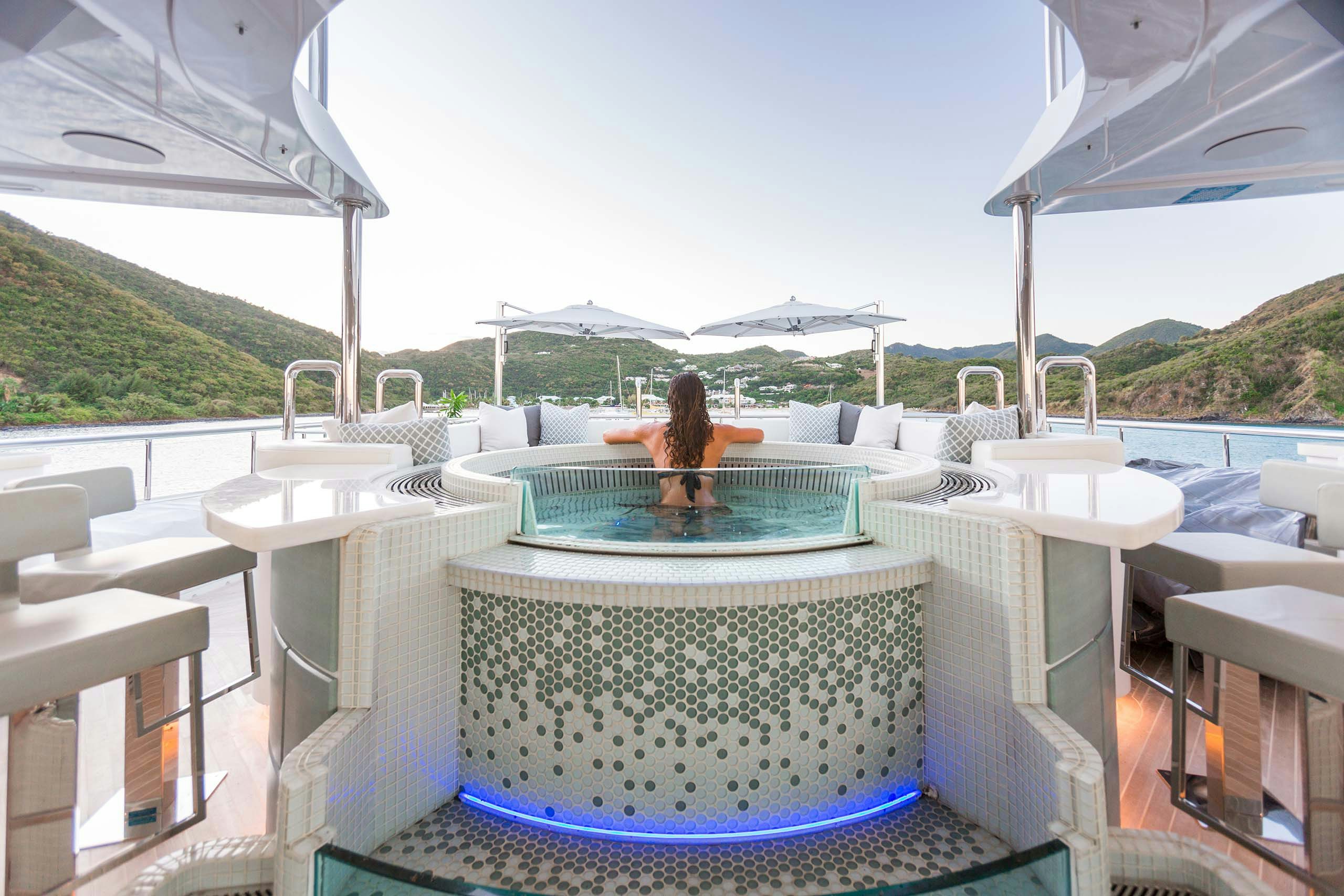 Woman relaxing in hot tub on board motor yacht KING BABY during a luxury yacht charter