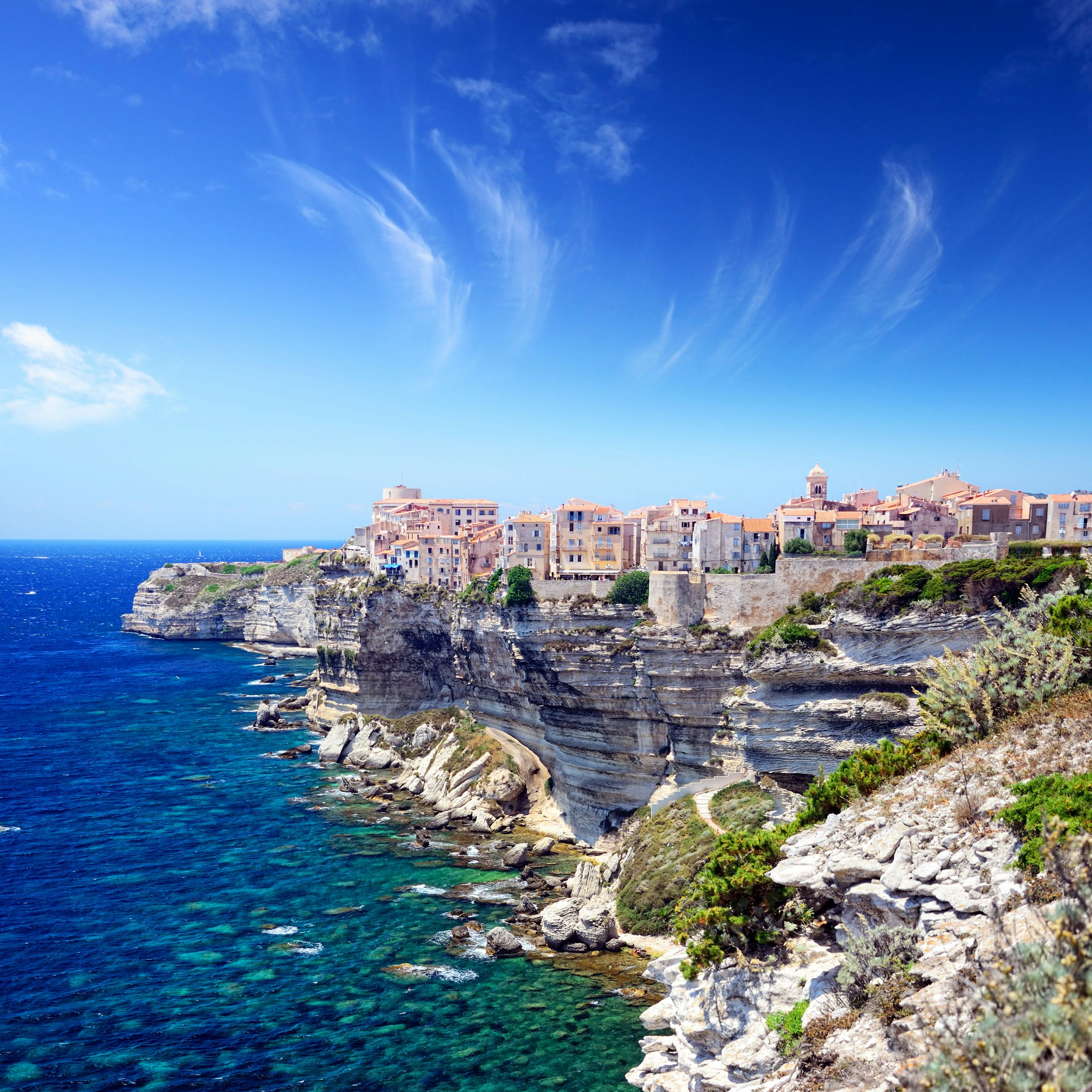 Bonifacio Cliffside Yachting | Majestic Corsica Awaits | Northrop & Johnson The dramatic cliffs of Bonifacio with the town perched above, as seen from the deck of a luxury yacht