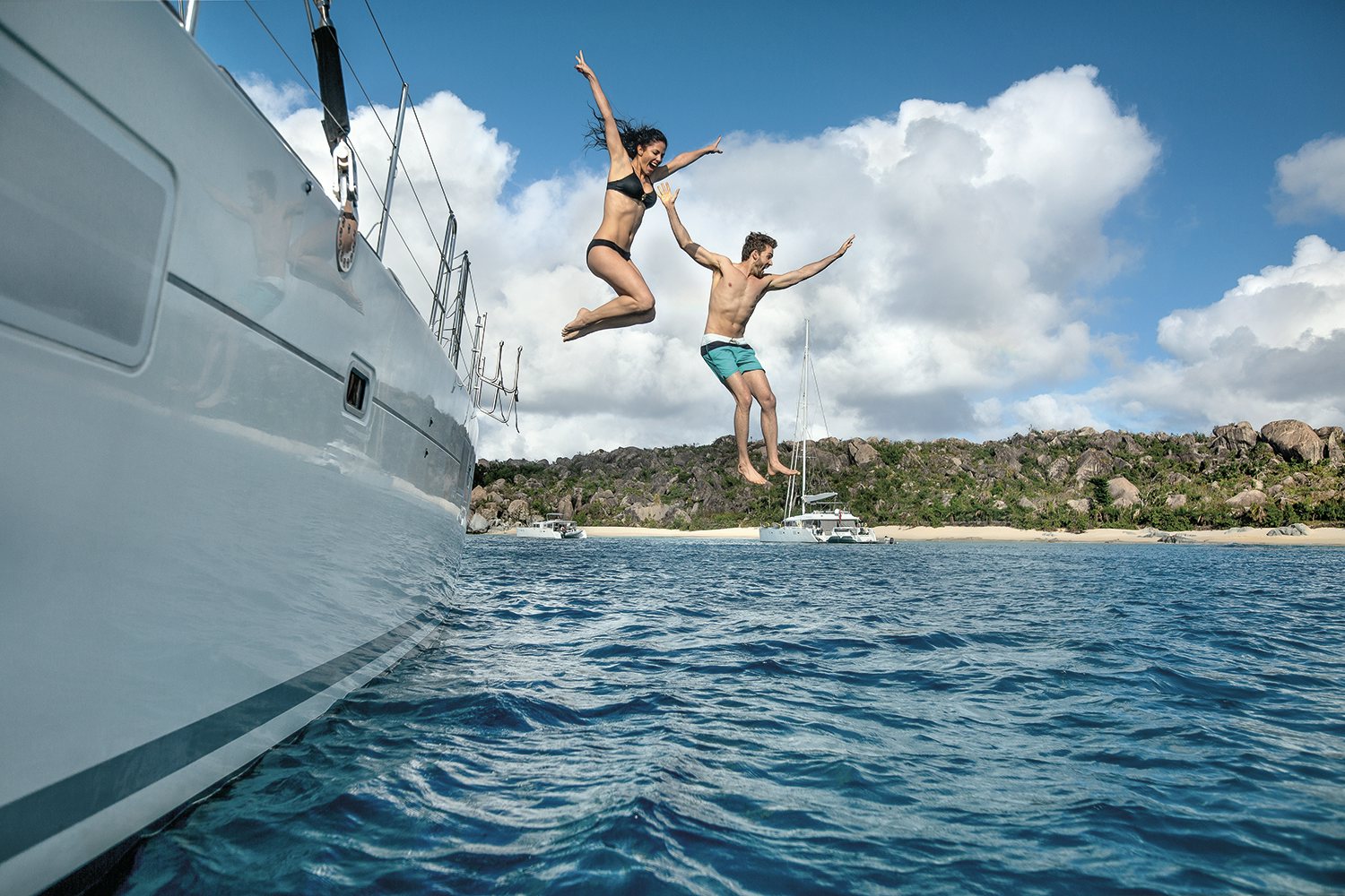 Couple jumping Off boat BVI