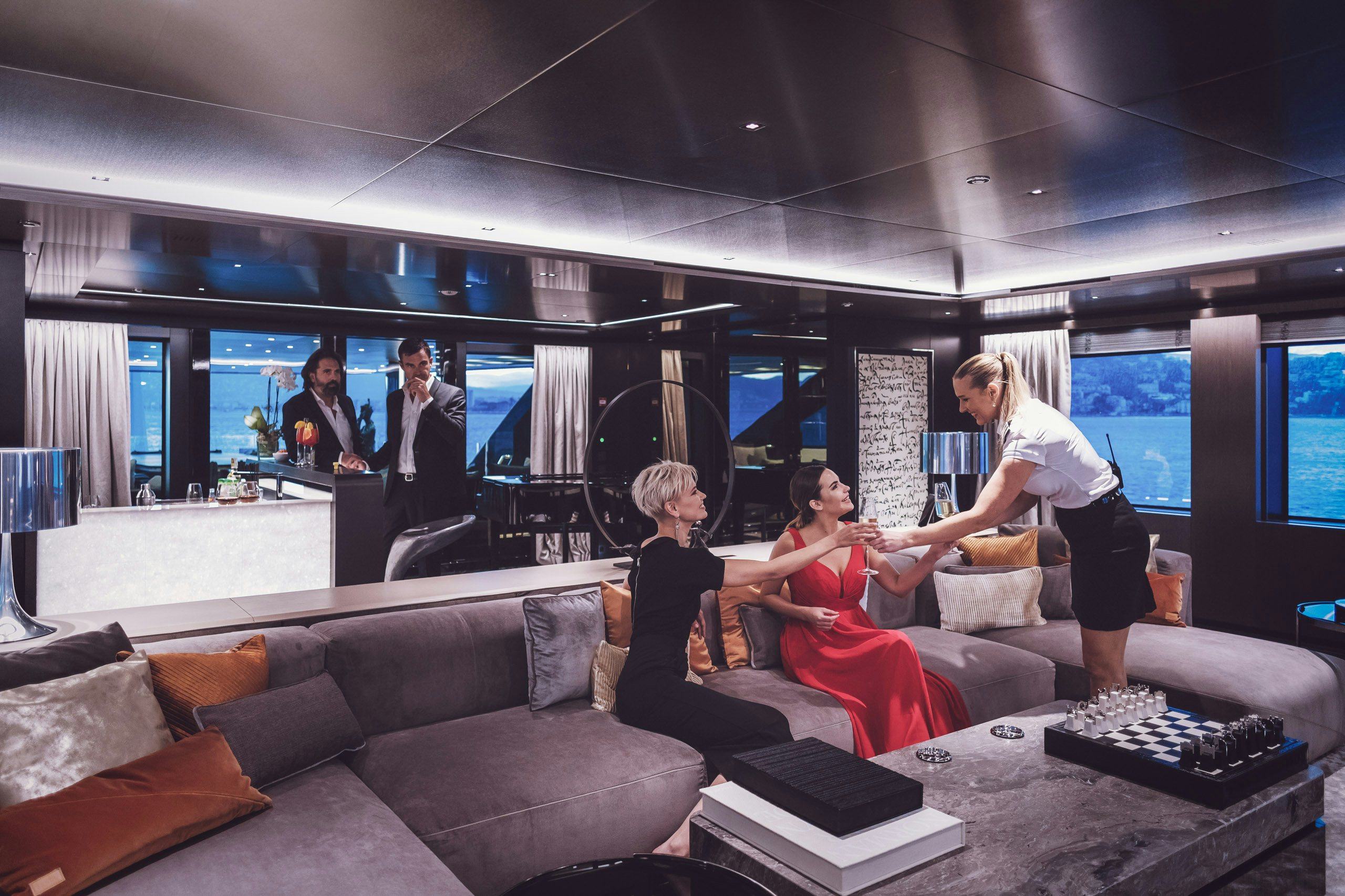 Two couples lounging on superyacht's salon