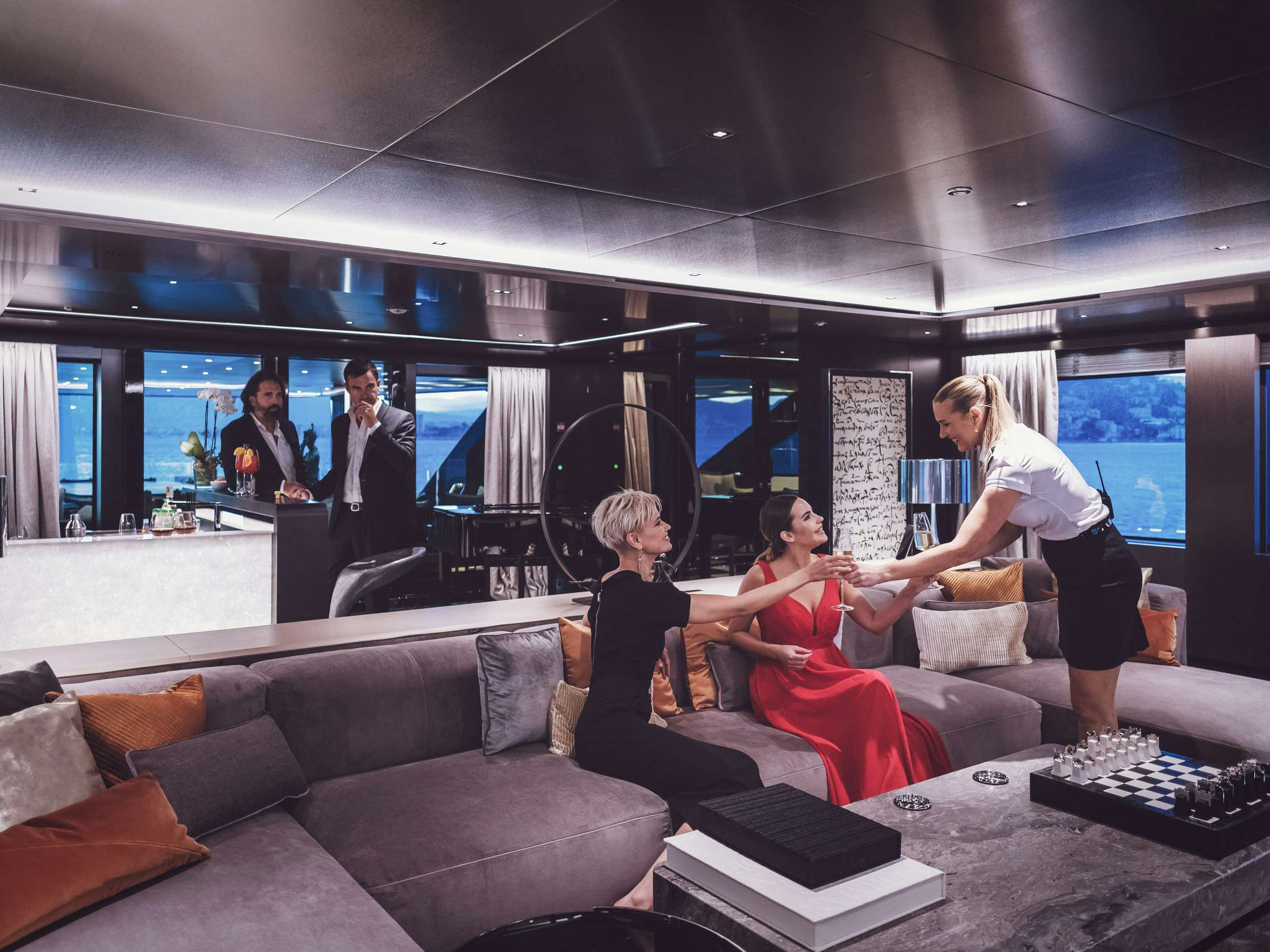 Two couples lounging on superyacht's salon