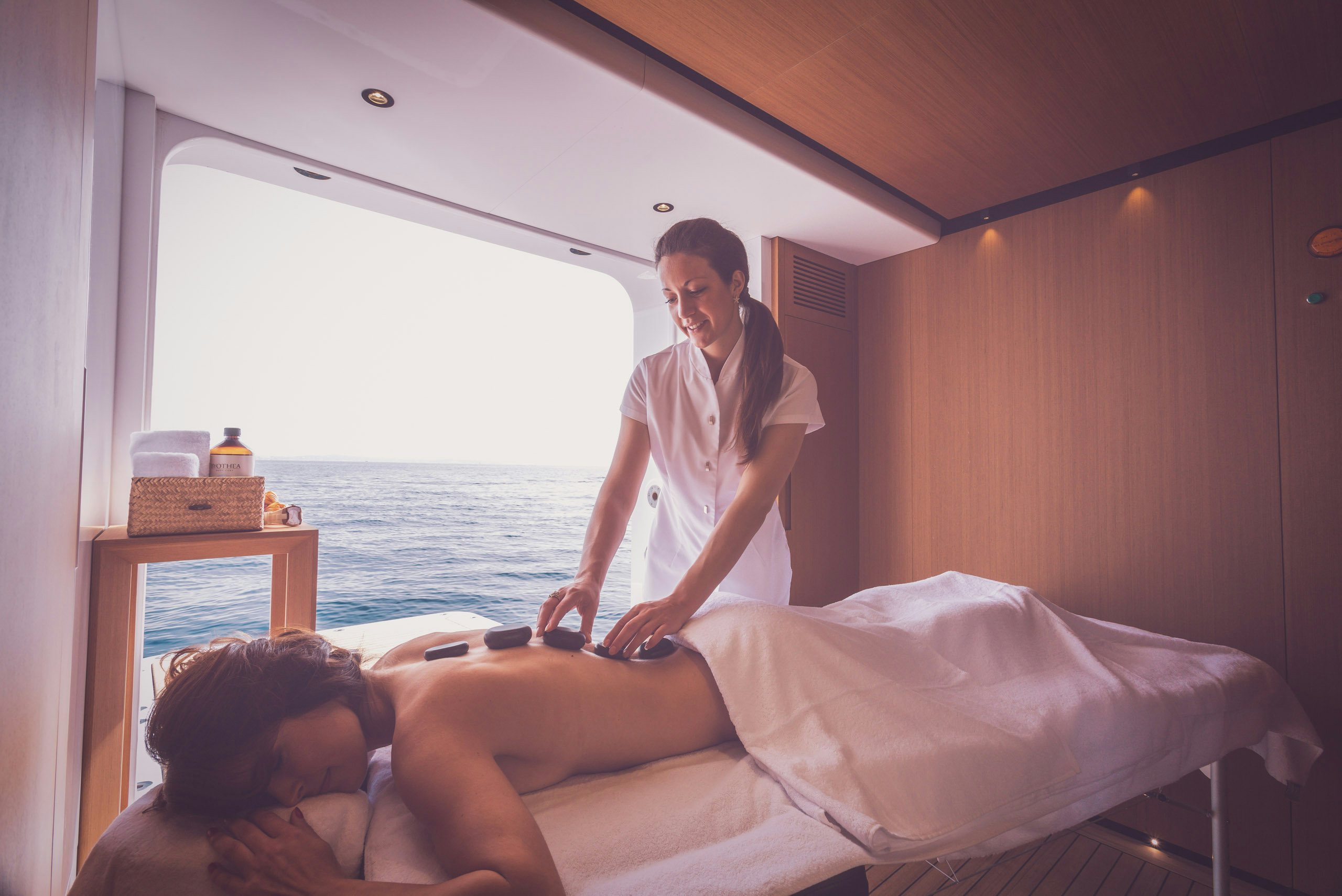 Masseuse performing massage on guest