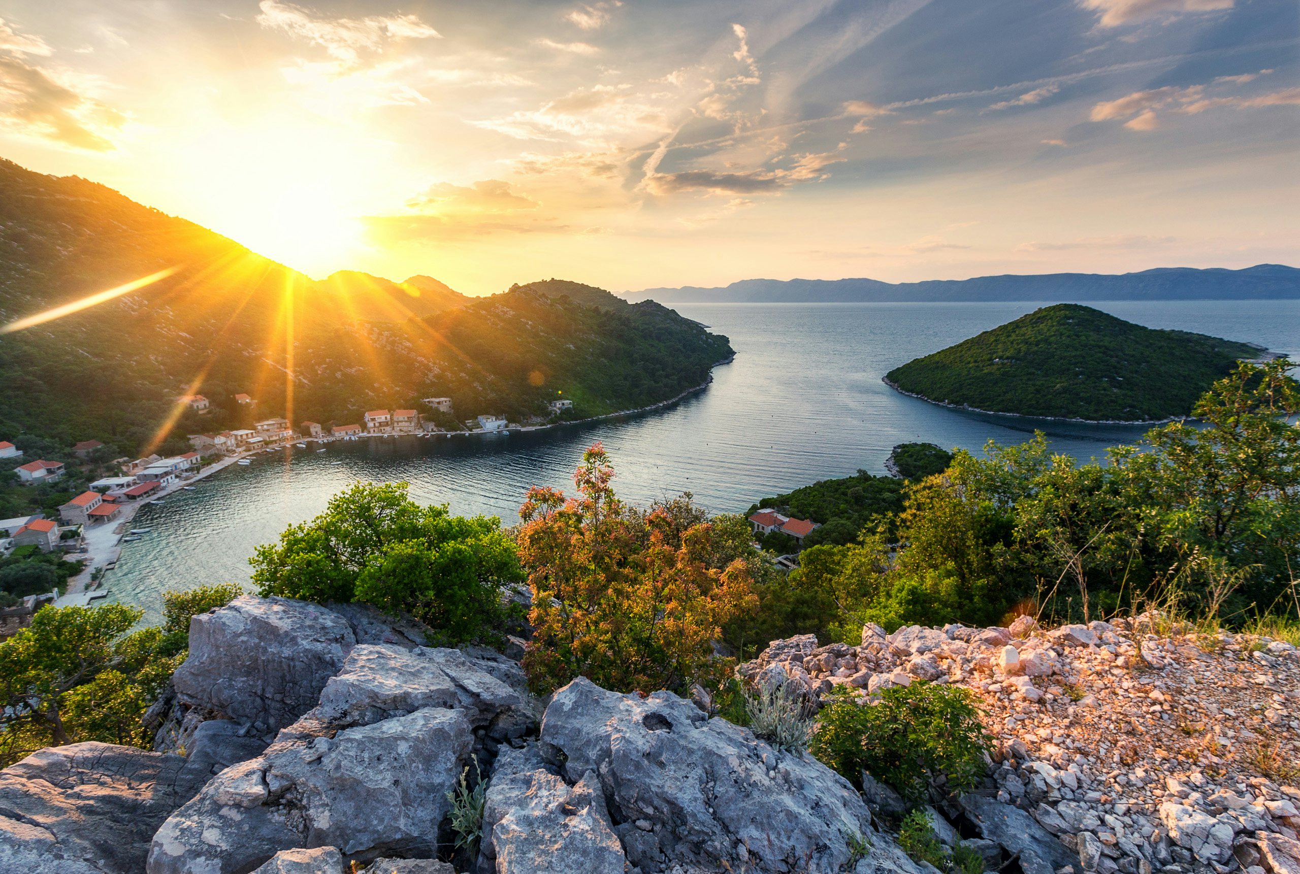 Discover Mljet - An Untouched Paradise for Yacht Charter in Croatia Serene sunset over the tranquil bay of Mljet, a premier yacht charter destination in Croatia.