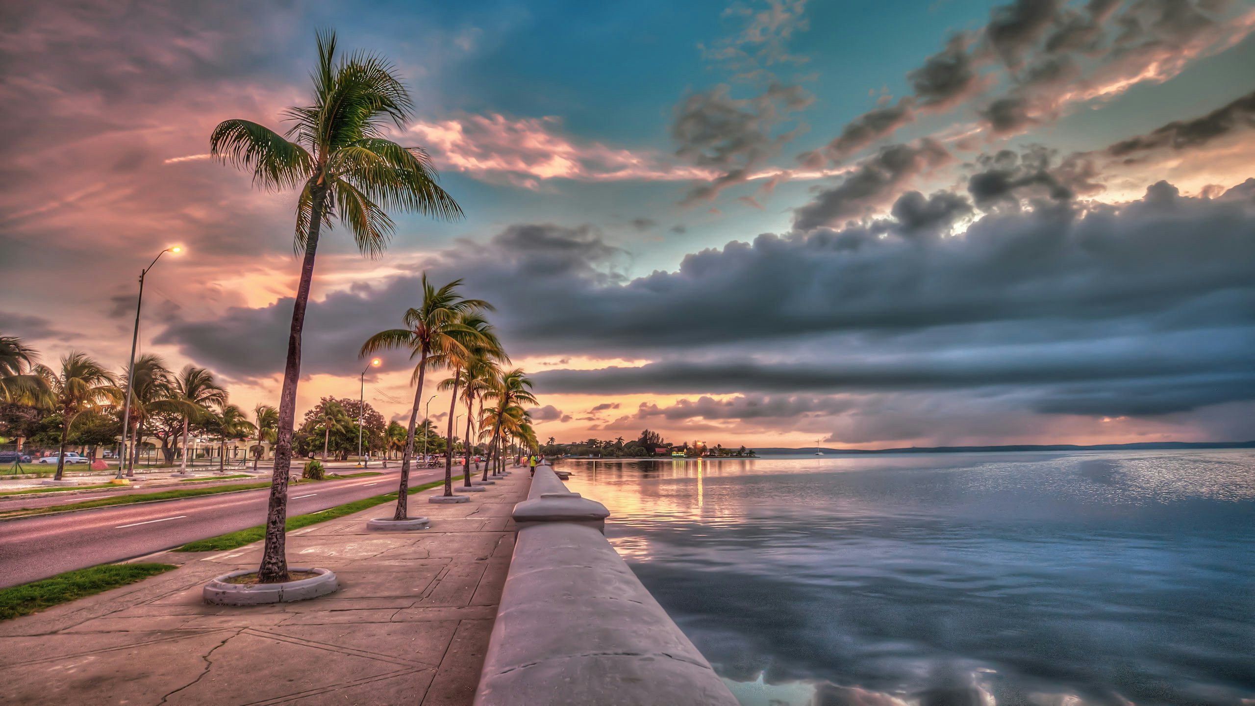 Cuba Superyacht Charter - cienfuegos cuba sunset picturesque beach with swaying palm trees