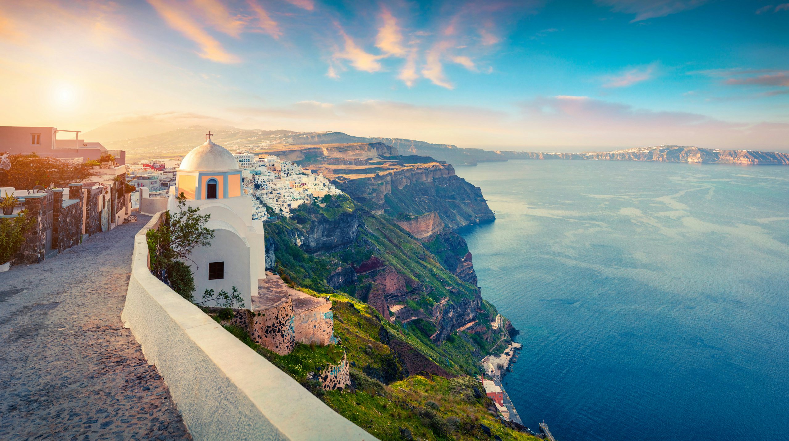 Santorini's iconic cliffside with a view of the caldera, a breathtaking scene for yacht charters in the Cyclades.