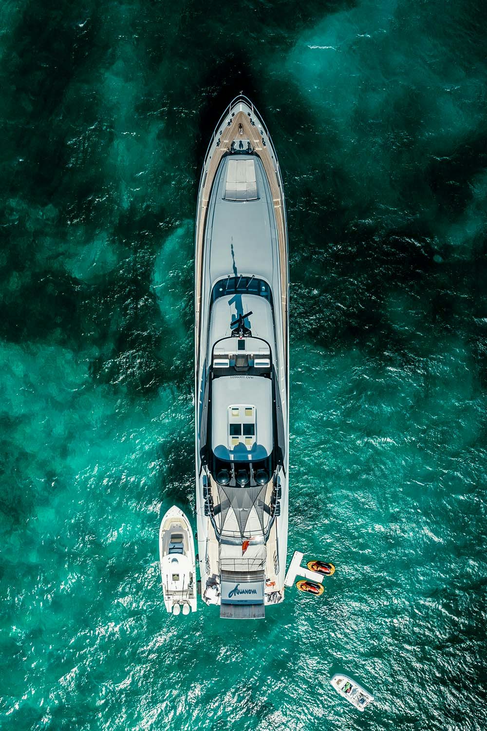 Aerial shot of AQUANOVA and her tender in blue green water
