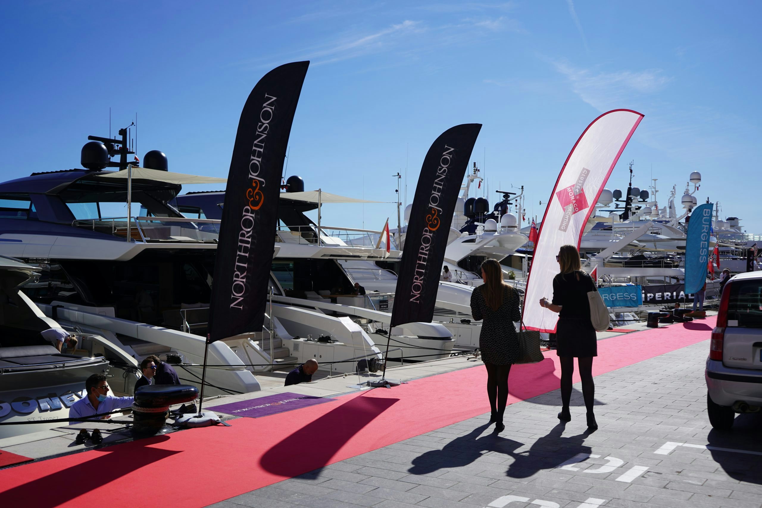 Cluster Yachting Monaco - Open Day Dock with red carpet, Northrop &amp; Johnson flags and yachts