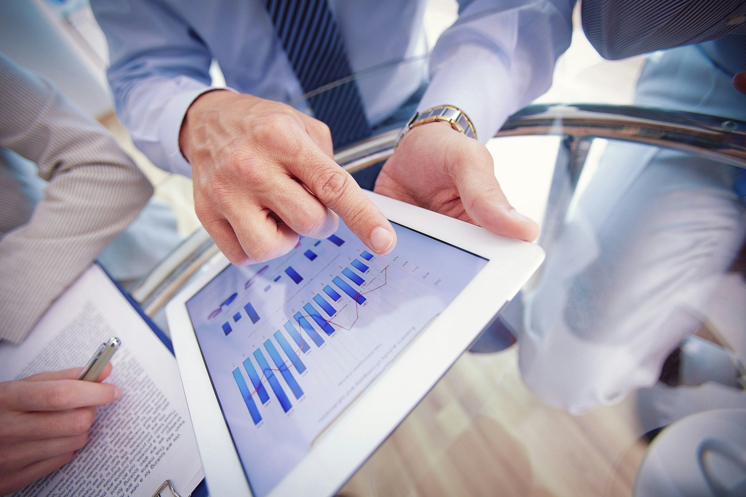 Digital Agency Close-up of a modern business team using tablet computer to work with data