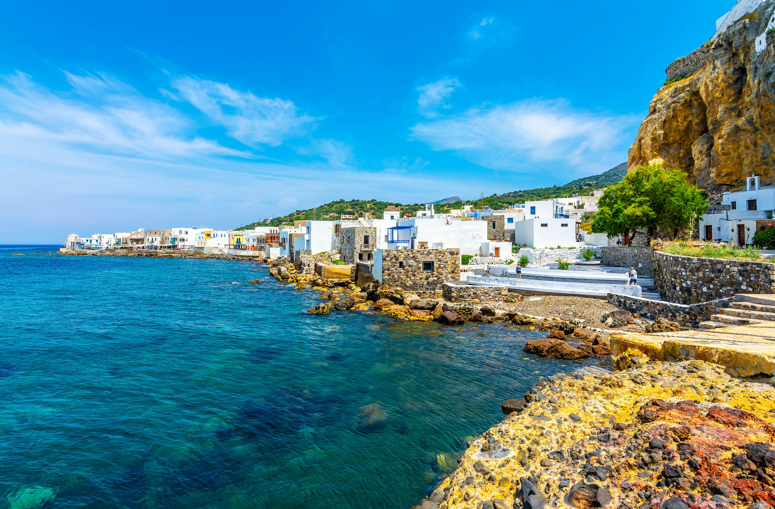 Mandraki Village Elegance - Nisyros Island's Yacht Charter Delight The tranquil seafront of Mandraki Village in Nisyros, lined with white-washed buildings, viewed from a yacht.
